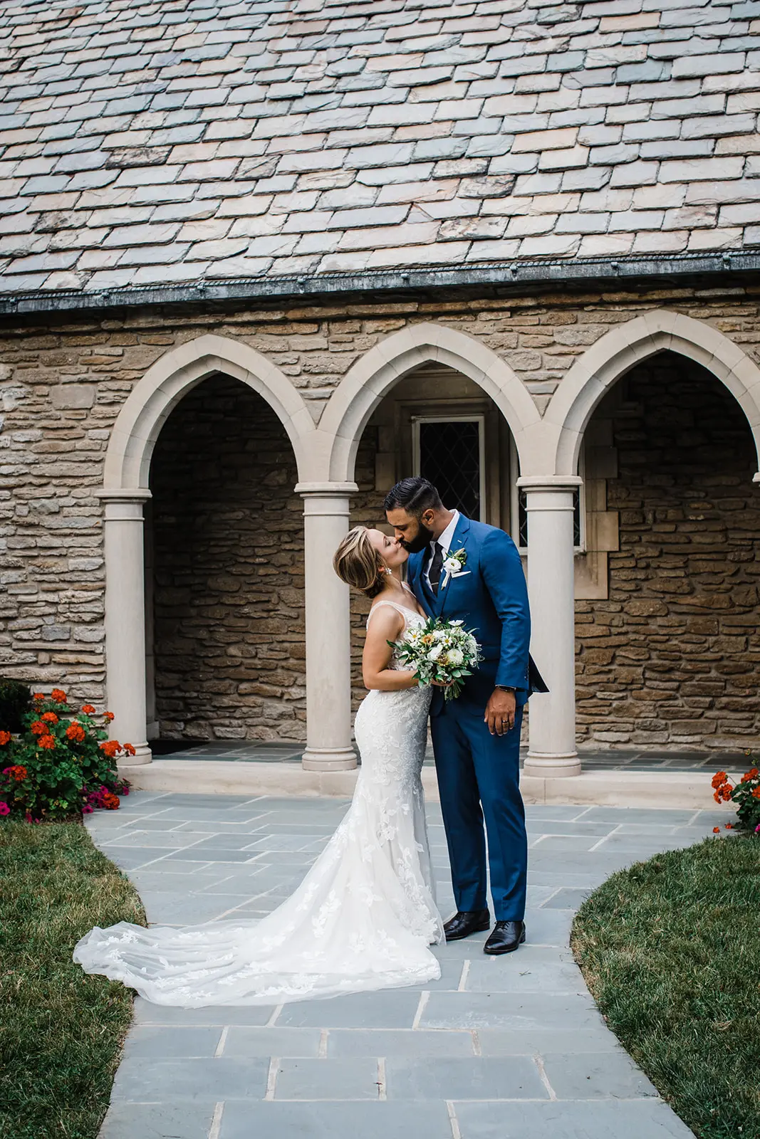 Bride Kissing Groom Wearing Bridal Dress Called Greenly by Maggie Sottero