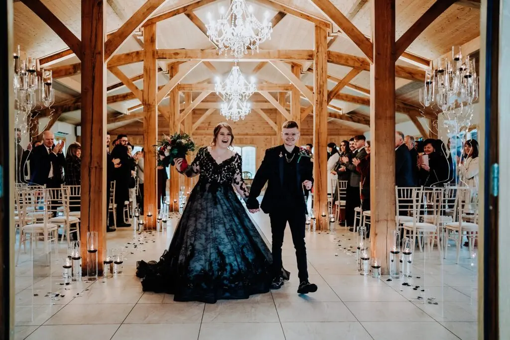 Bride Wearing Gothic Black Wedding Dress Called Zander By Maggie Sottero With Groom At Their Ceremony