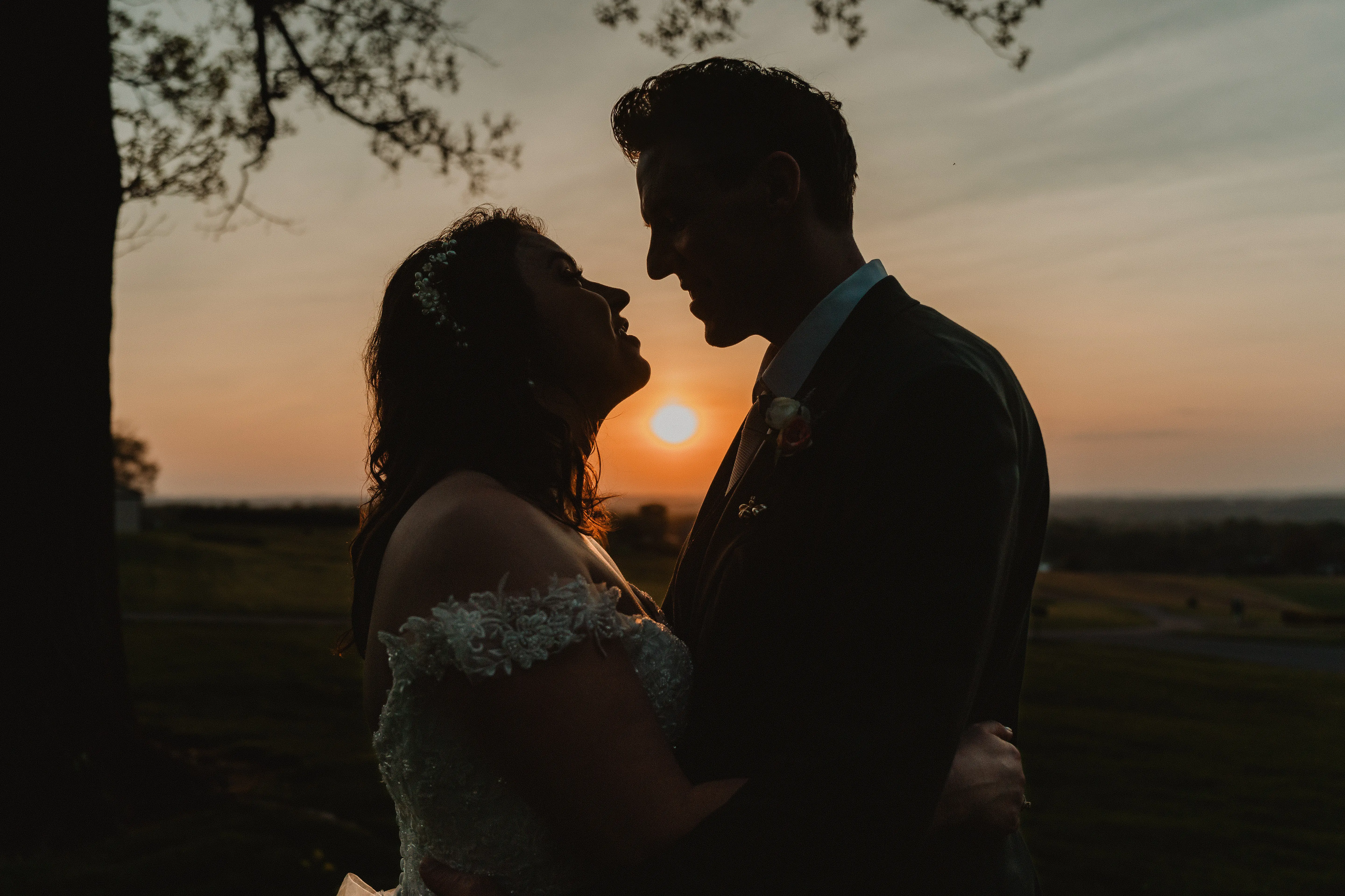 Bride wearing Mason by Sottero and Midgley and her husband at sunset