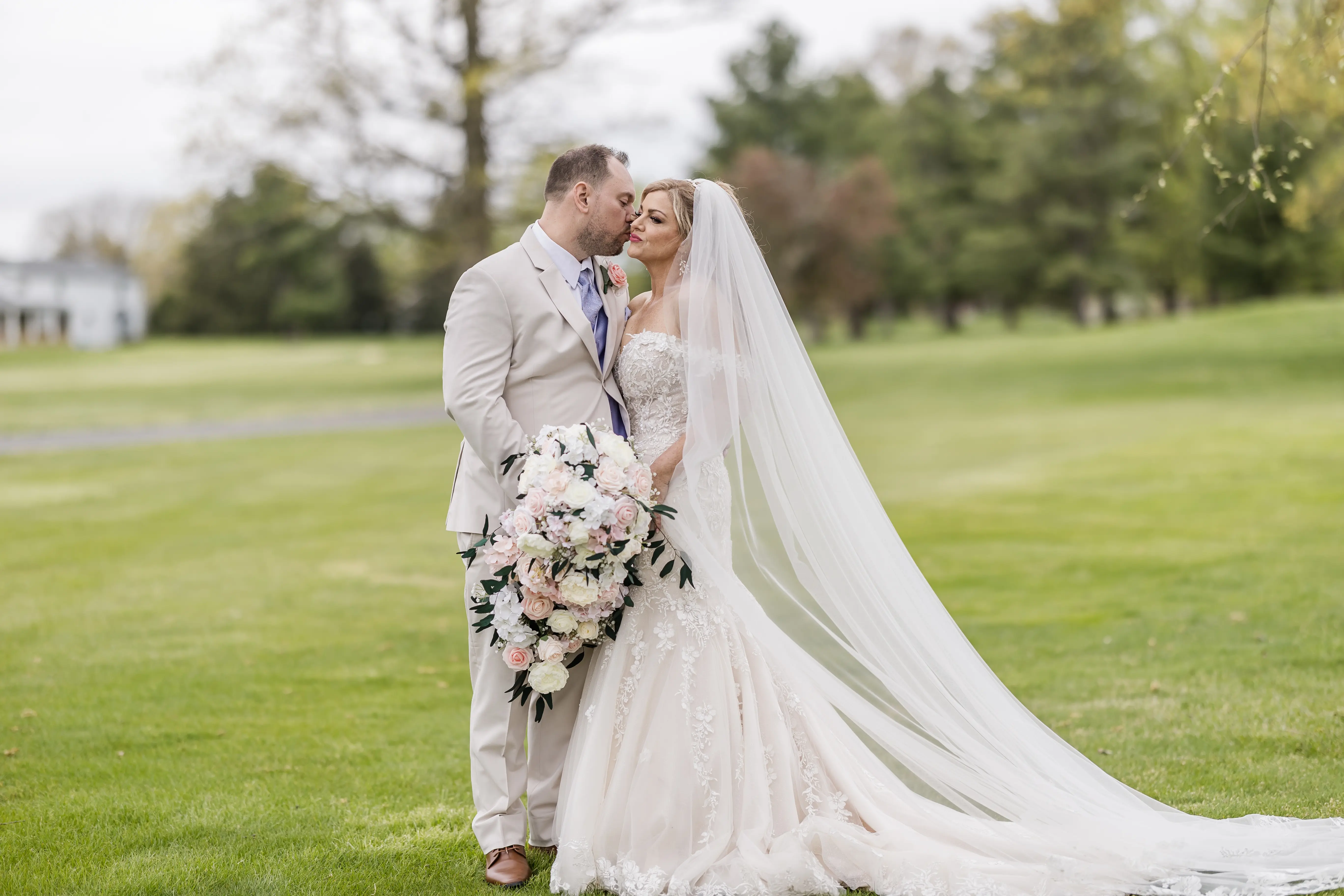 Bride wearing Lennon by Maggie Sottero being kissed by her husband