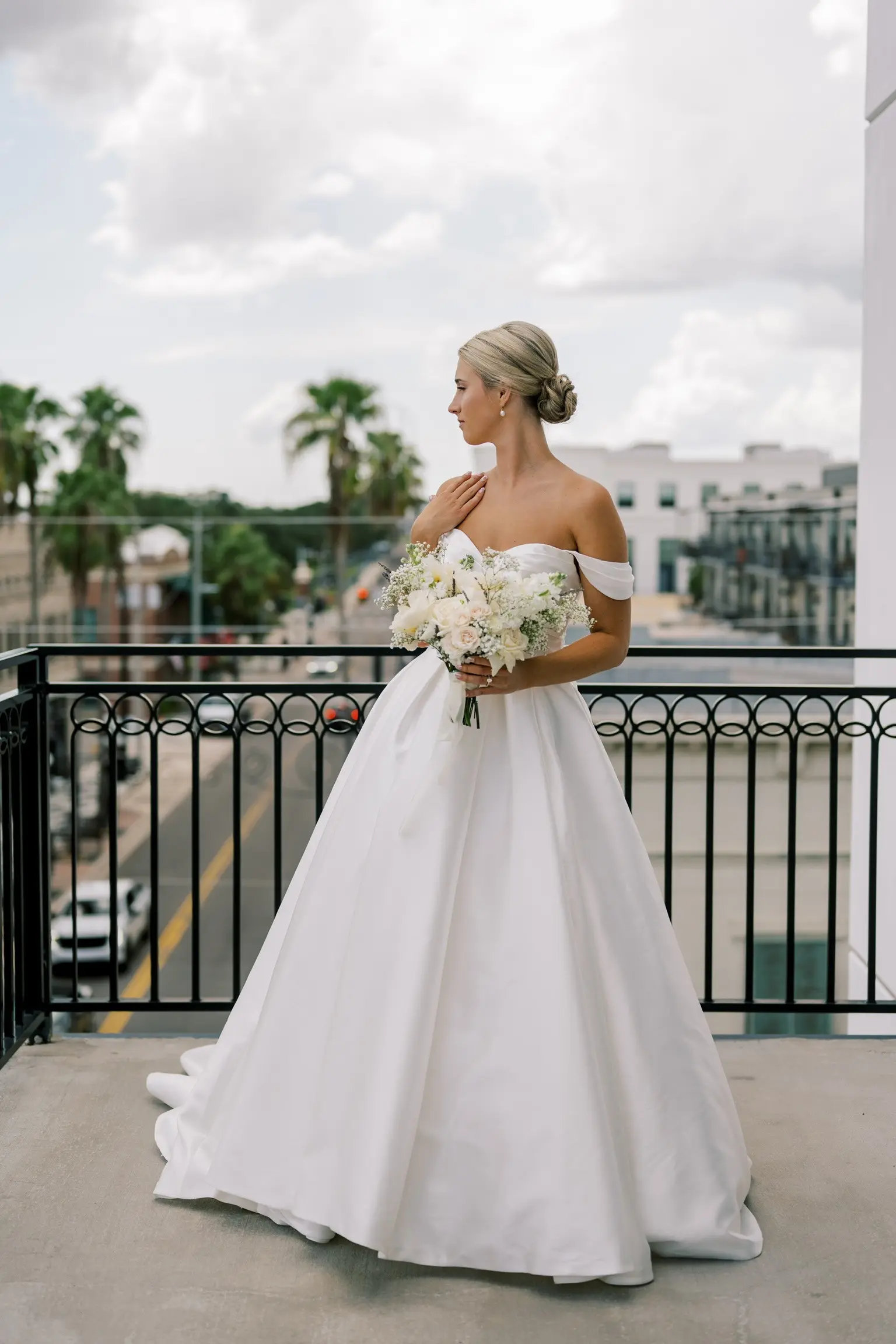 Bride wearing Zinaida by Maggie Sottero looking out over a balcony