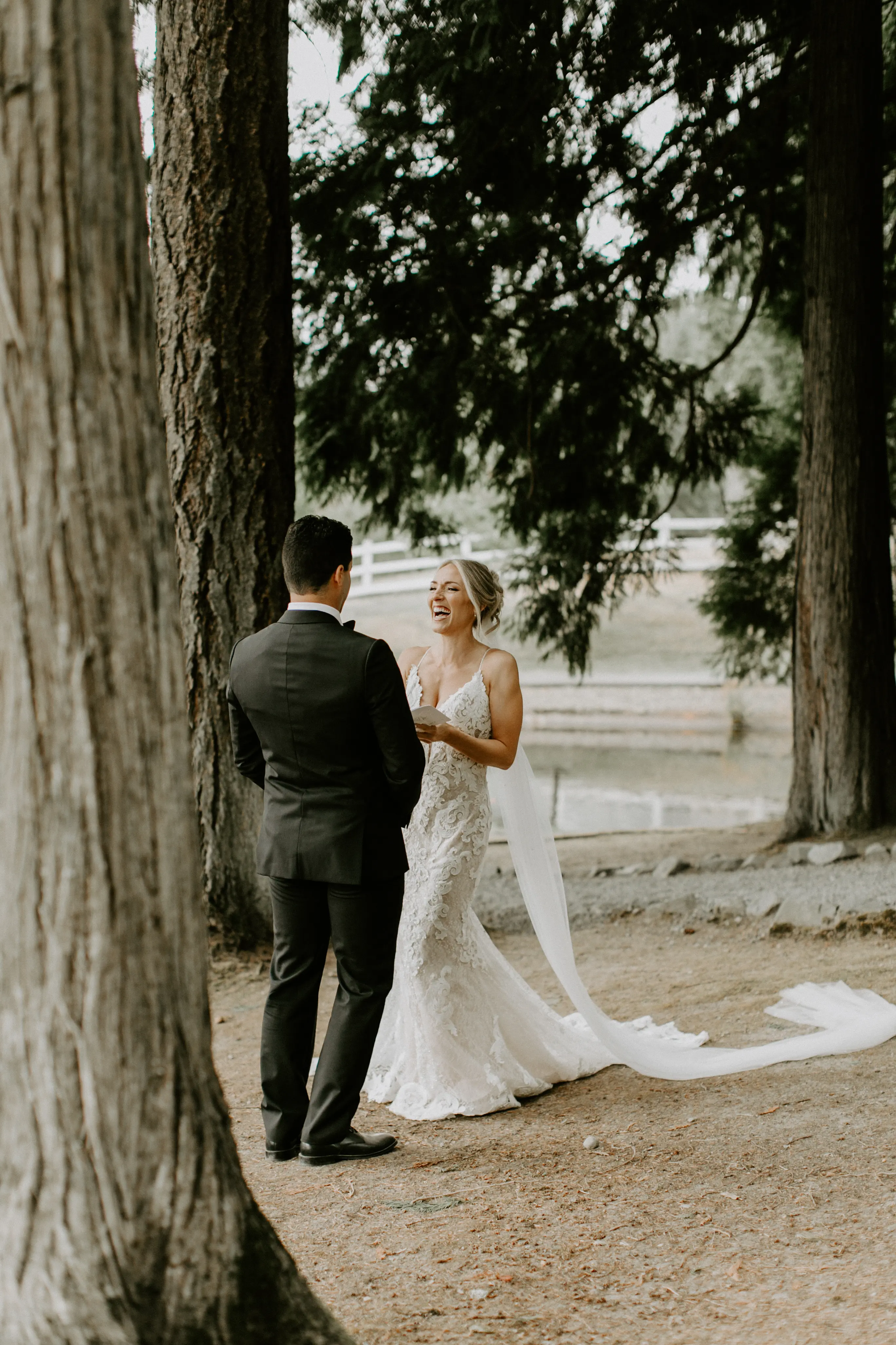 Bride with groom wearing romantic lace sheath wedding dress