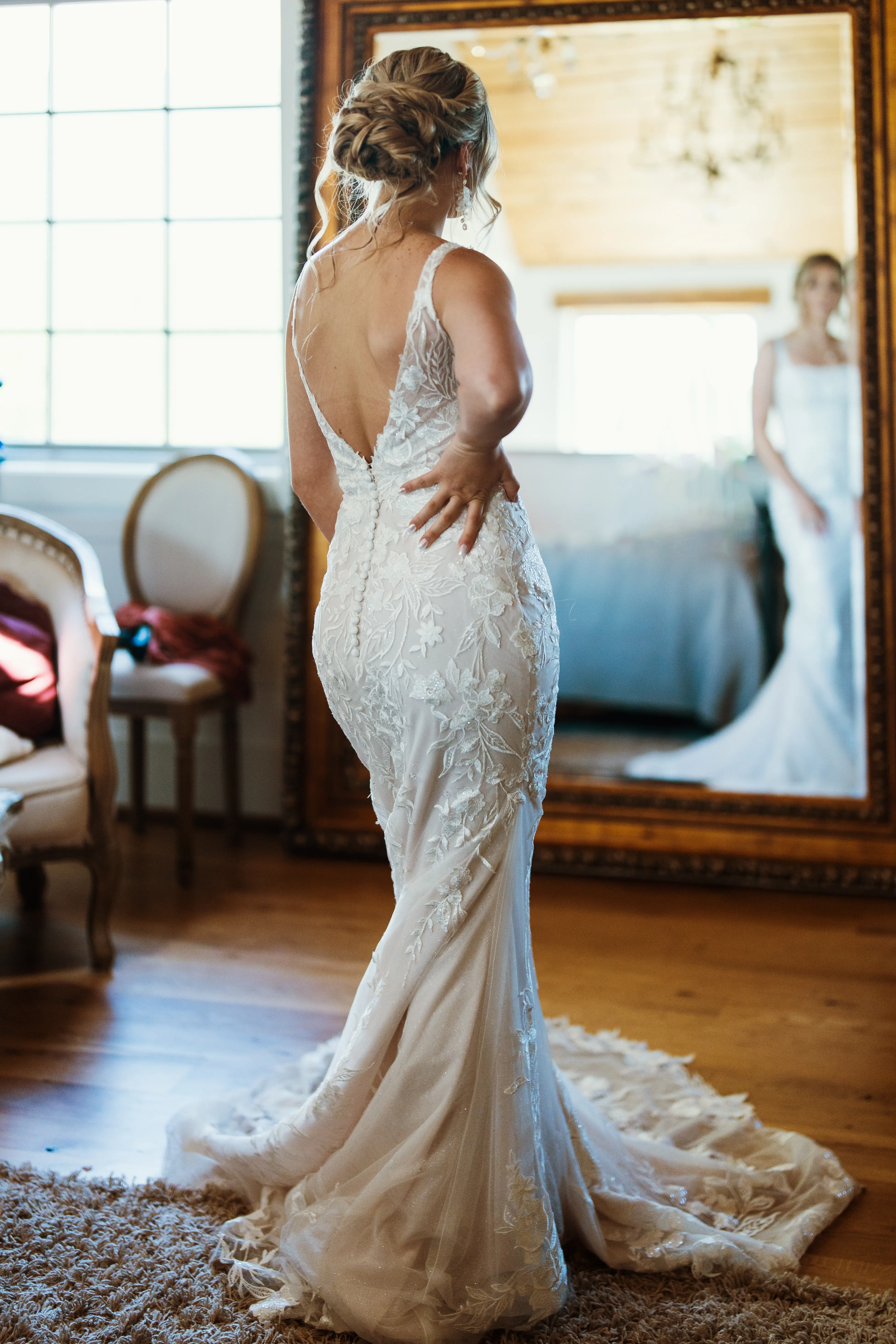 Bride wearing Albany wedding dress by Maggie Sottero looking in the miror