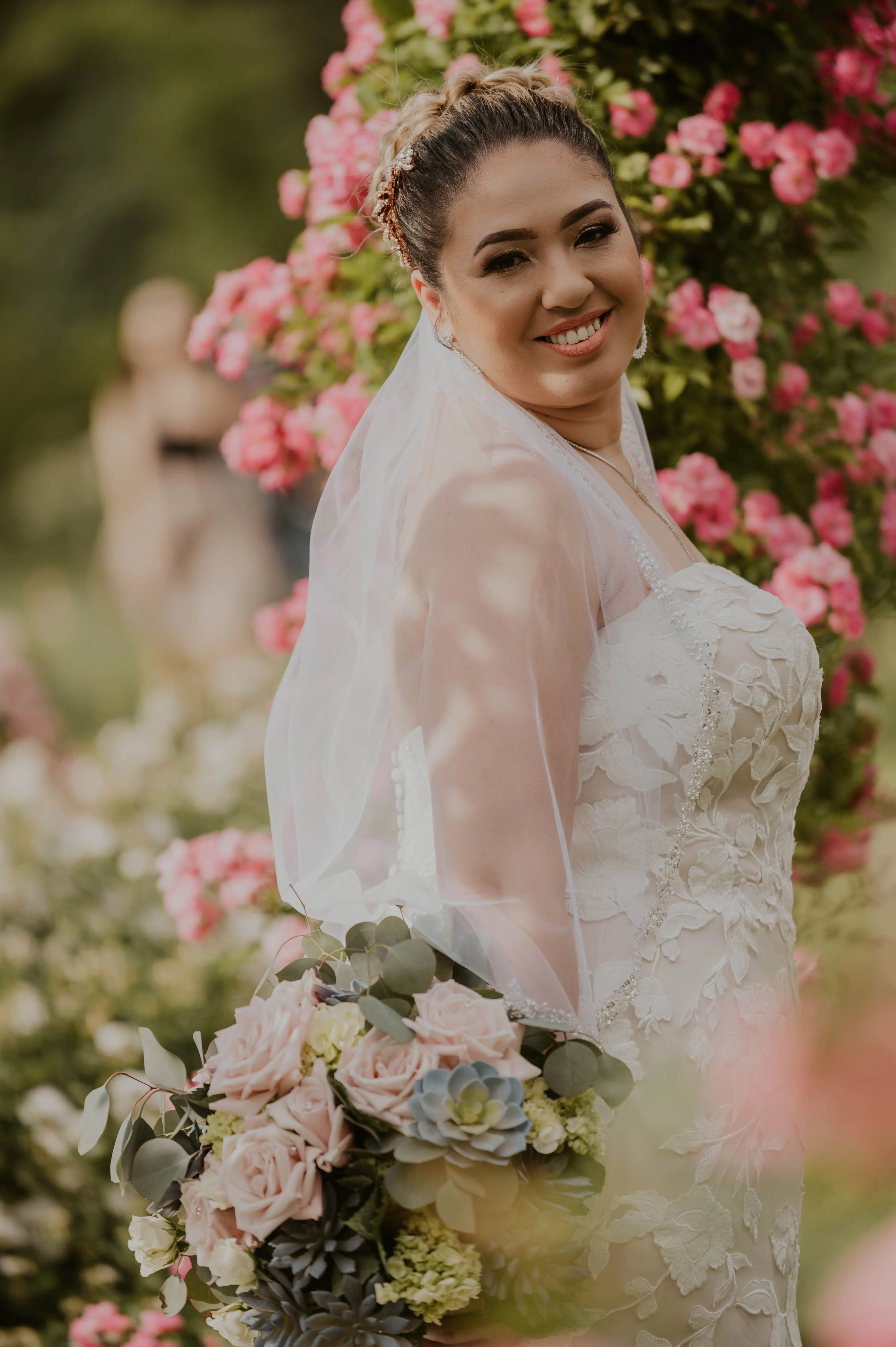 Bride In A Garden Wearing A White Lace Wedding Dress Named Hattie By Rebecca Ingram
