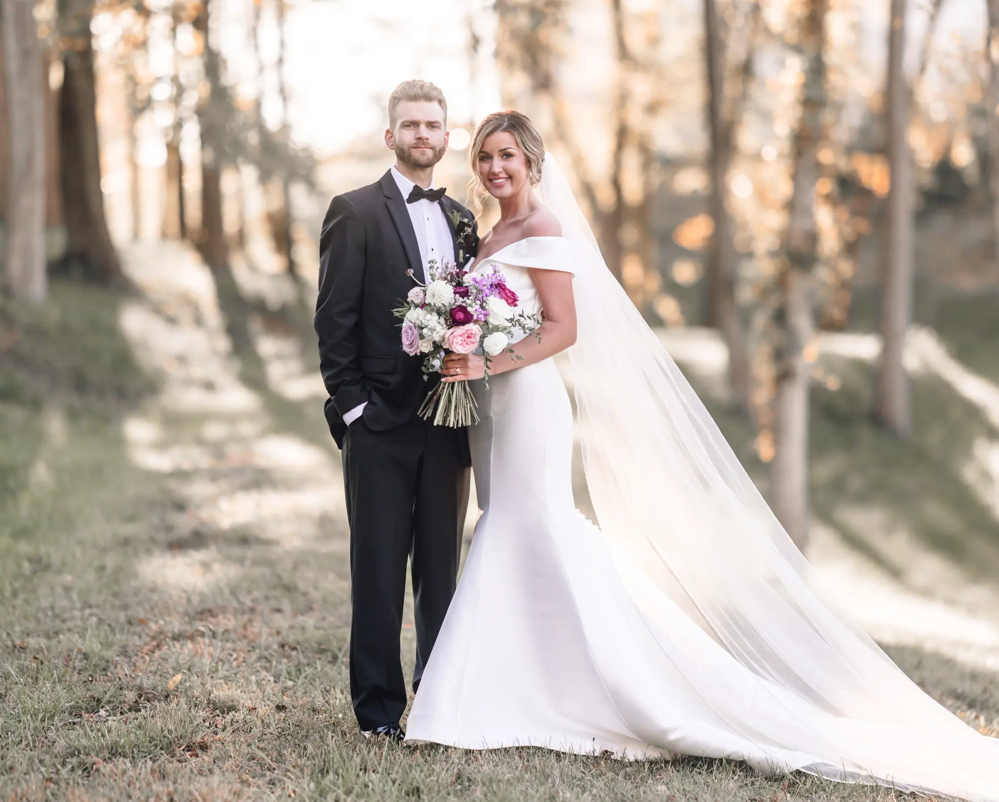 Groom Posing With Bride In Off The Shoulder Fit And Flare Wedding Dress Named Josie By Rebecca Ingram