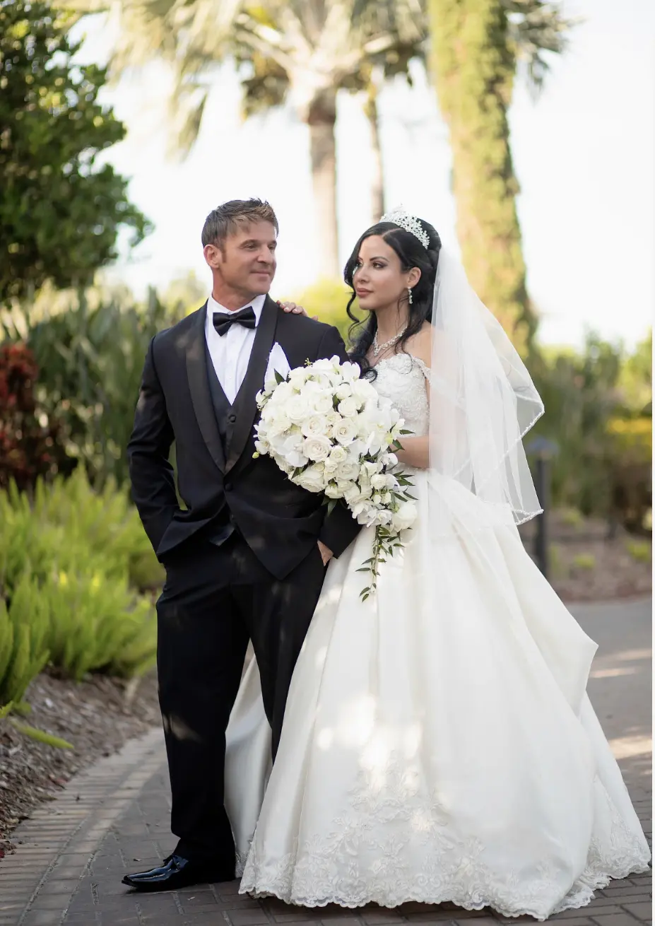 Bride wearing elegant satin ballgown called Kimora by Sottero and Midgley with groom