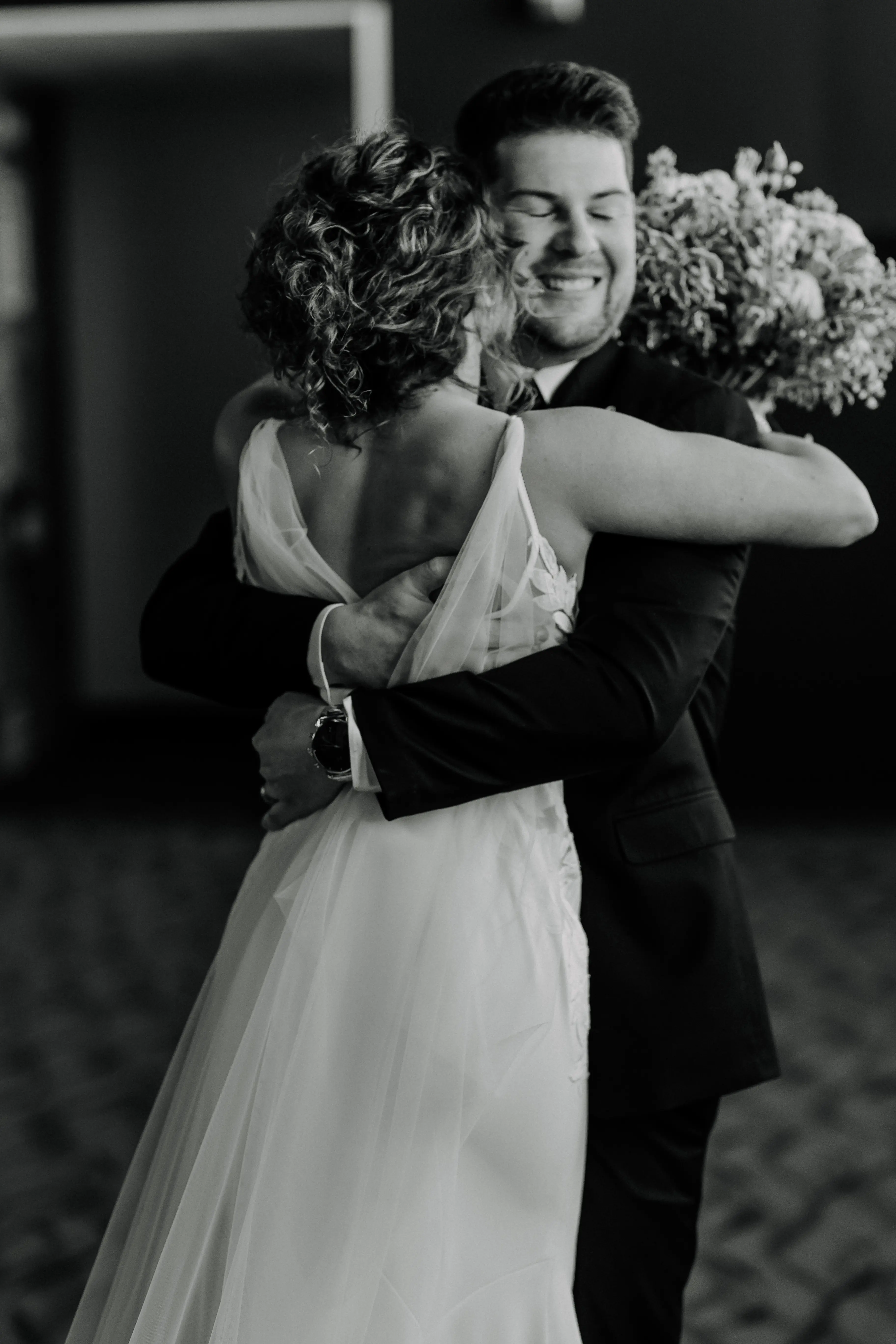Bride wearing Dionne by Rebecca Ingram hugging her husband
