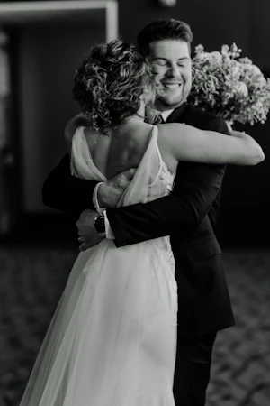 Bride wearing Dionne by Rebecca Ingram hugging her husband