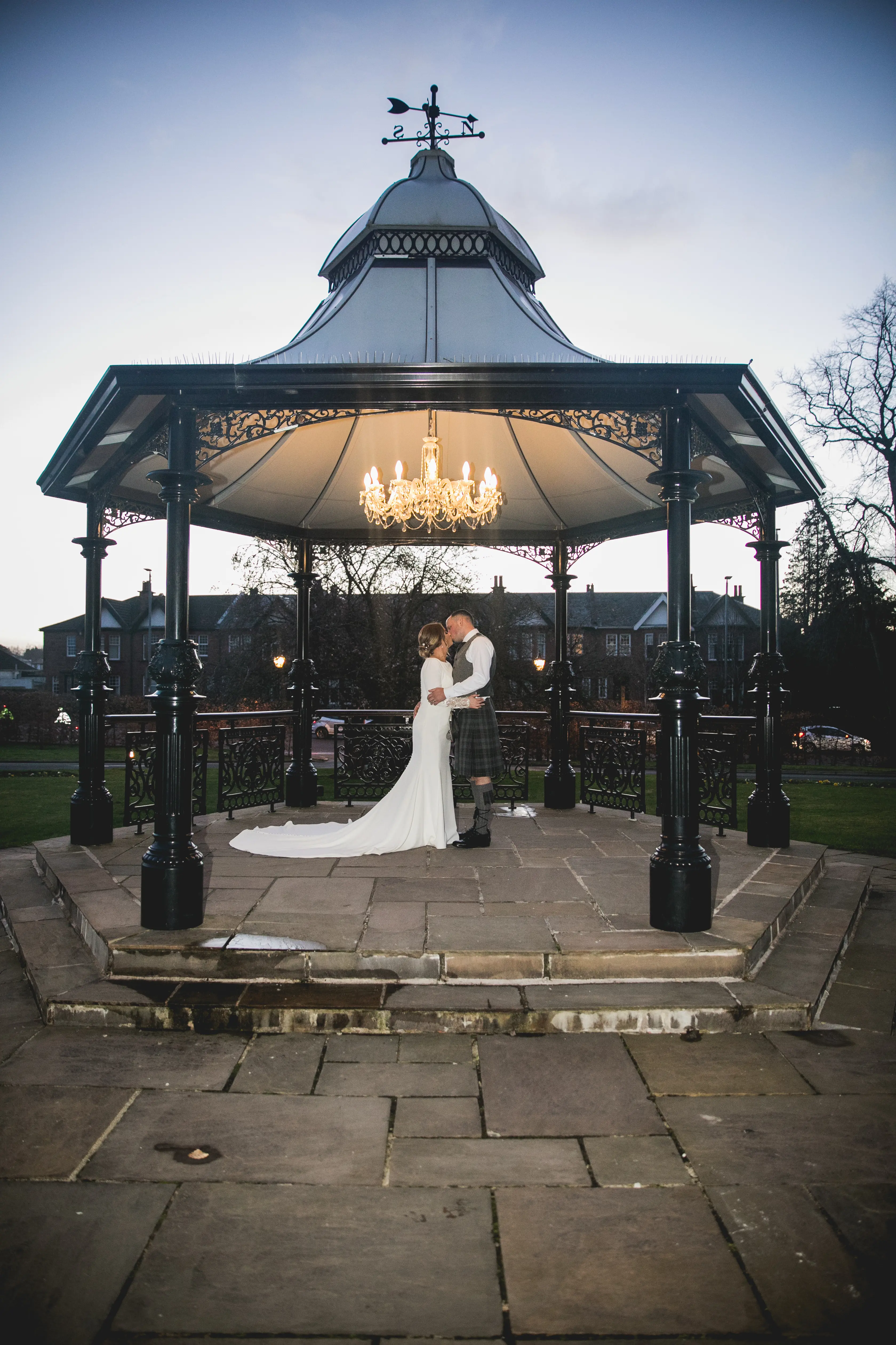 Groom Kissing Bride in Crepe Fit-and-Flare Wedding Dress with Beaded Illusion Embroidery Featuring Swarovski Crystals Called Aston by Sottero & Midgley