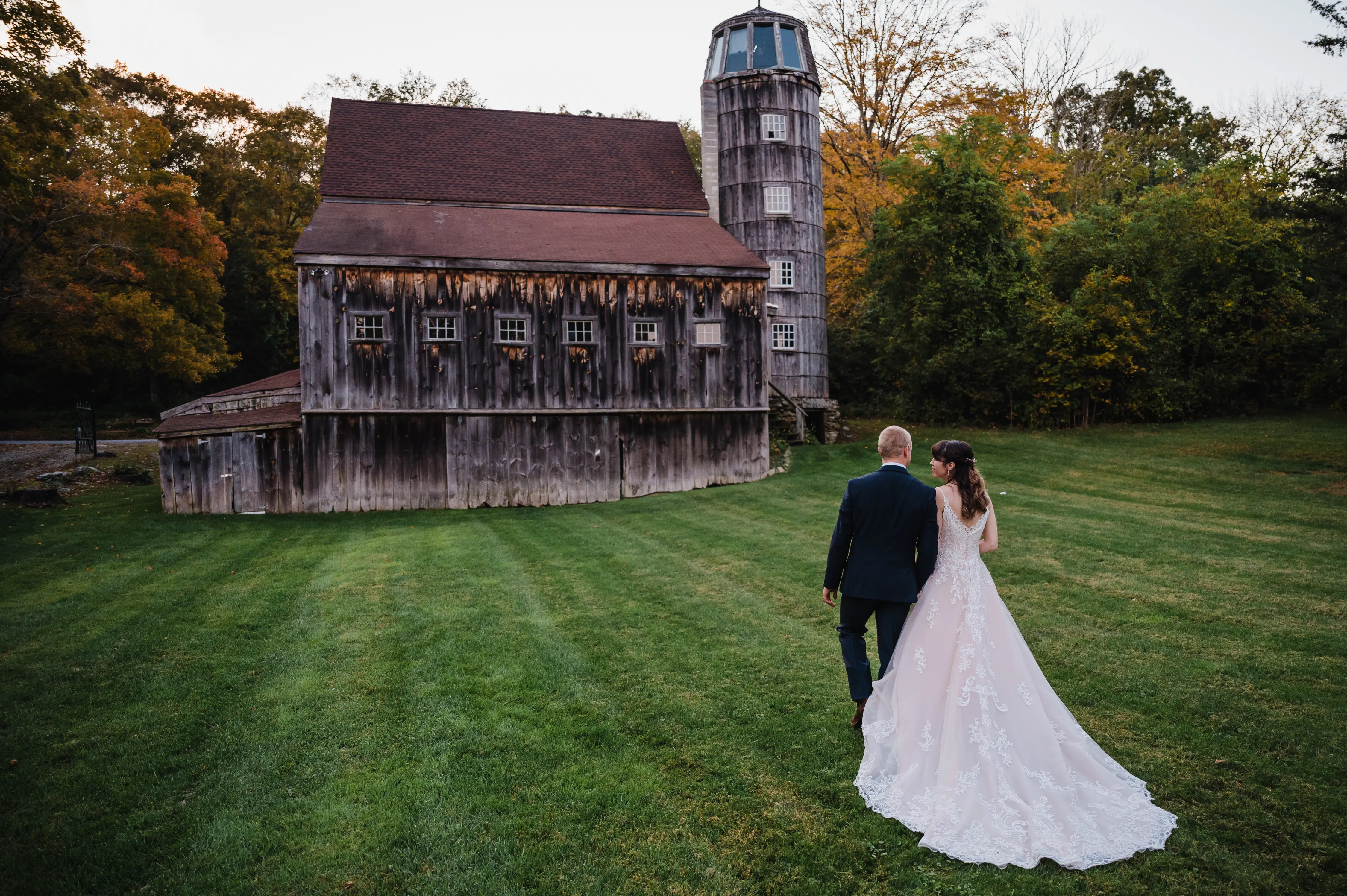 Bride Wearing Lace A-Line Wedding Dress Called Wallis By Maggie Sottero And Groom Next To An Abandoned Barn