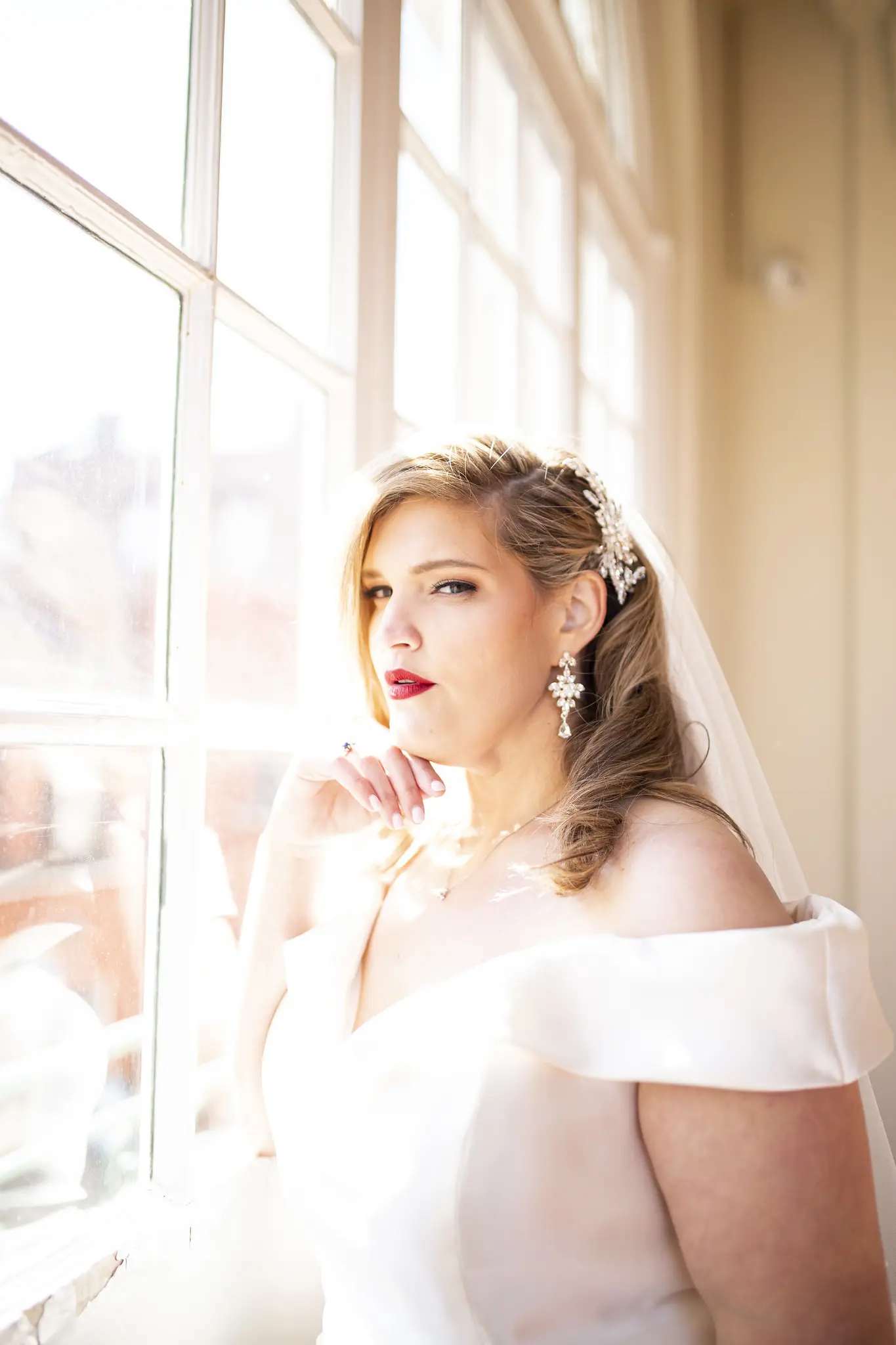 Bride Wearing Vintage Glamour Timeless Off-The-Shoulder Fit-And-Flare Wedding Dress Called Josie By Rebecca Ingram