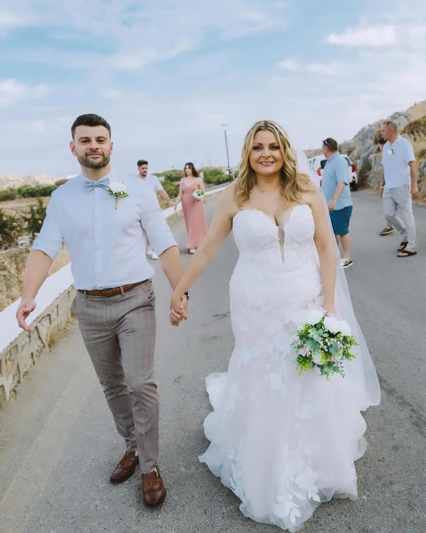 Bride wearing Hattie wedding dress by Rebecca Ingram walking with her husband