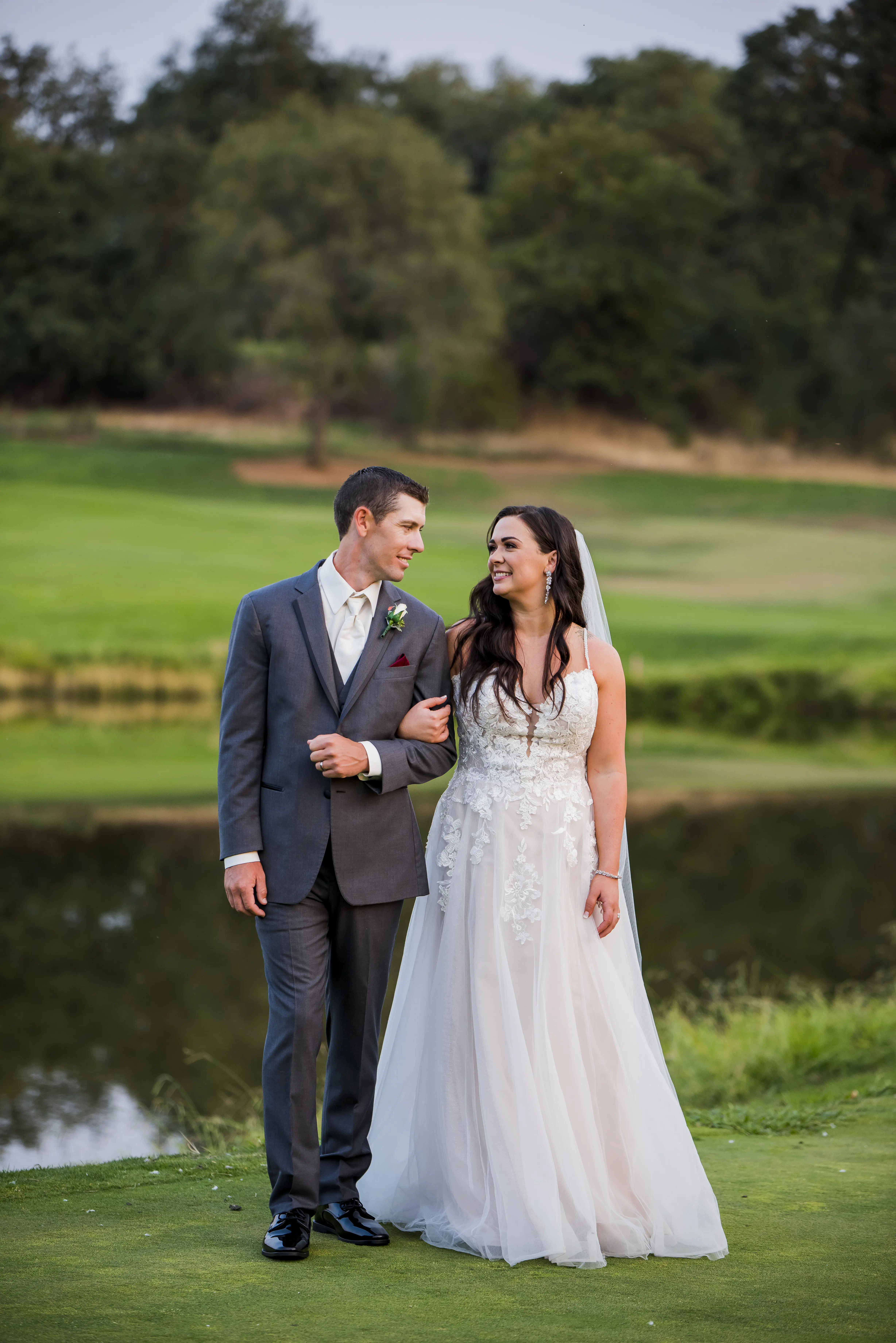 Bride wearing Princess Wedding Gown called Stevie by Maggie Sottero walking with her groom