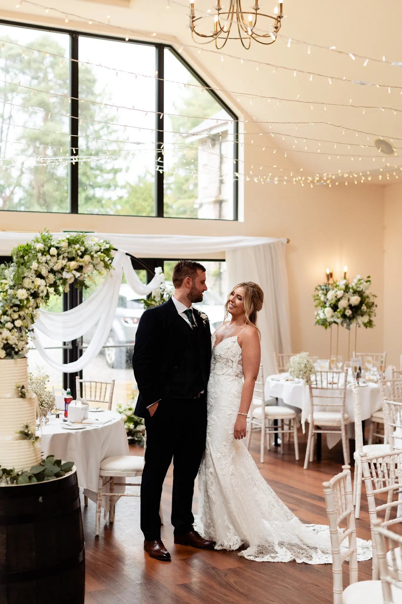 Groom with Bride in Romantic Lace Sheath Wedding Gown with Shimmering Lace Motifs Called Tuscany Lynette by Maggie Sottero