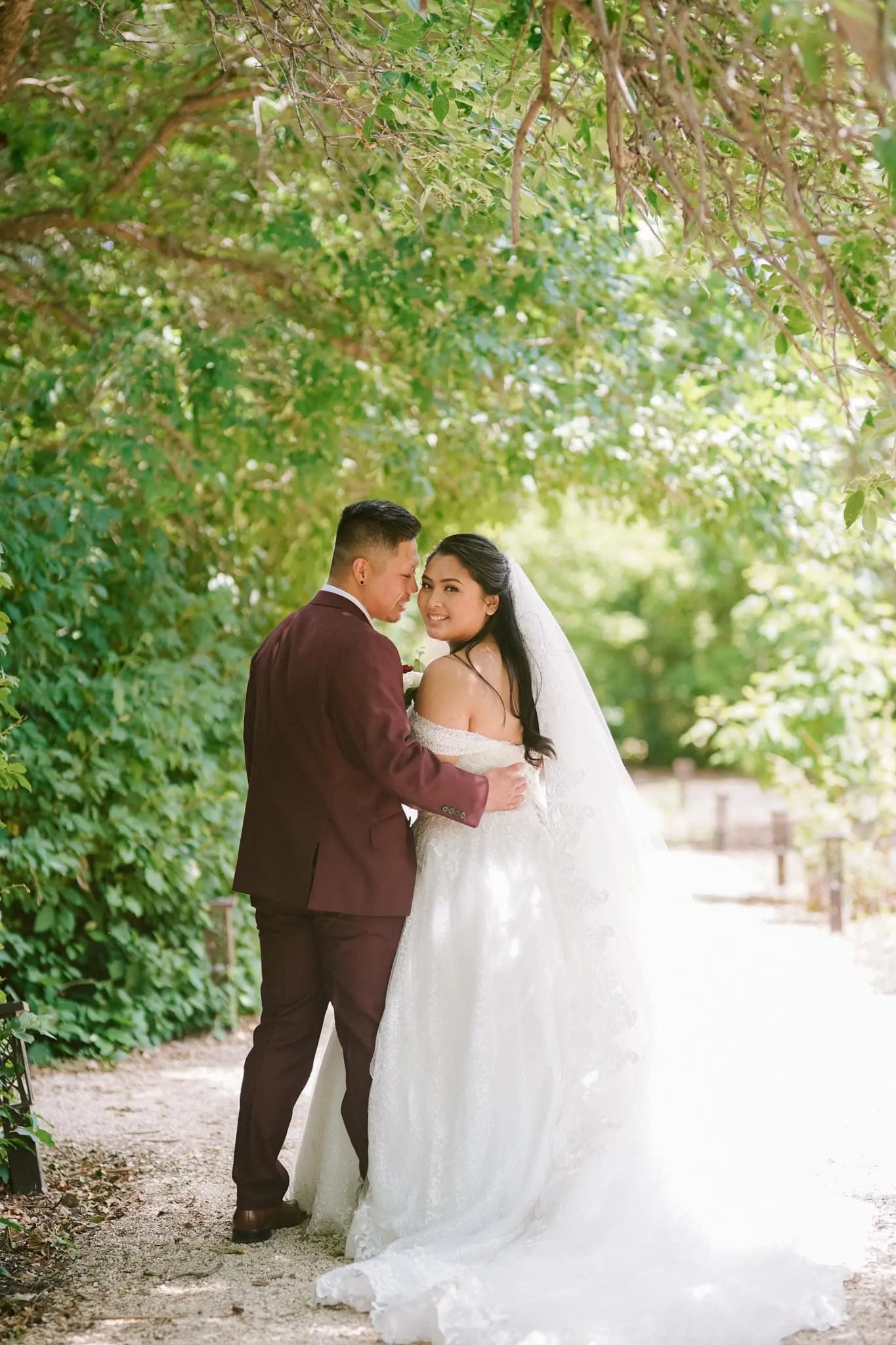 Groom looking at bride wearing ivory ballgown called Tristyn.