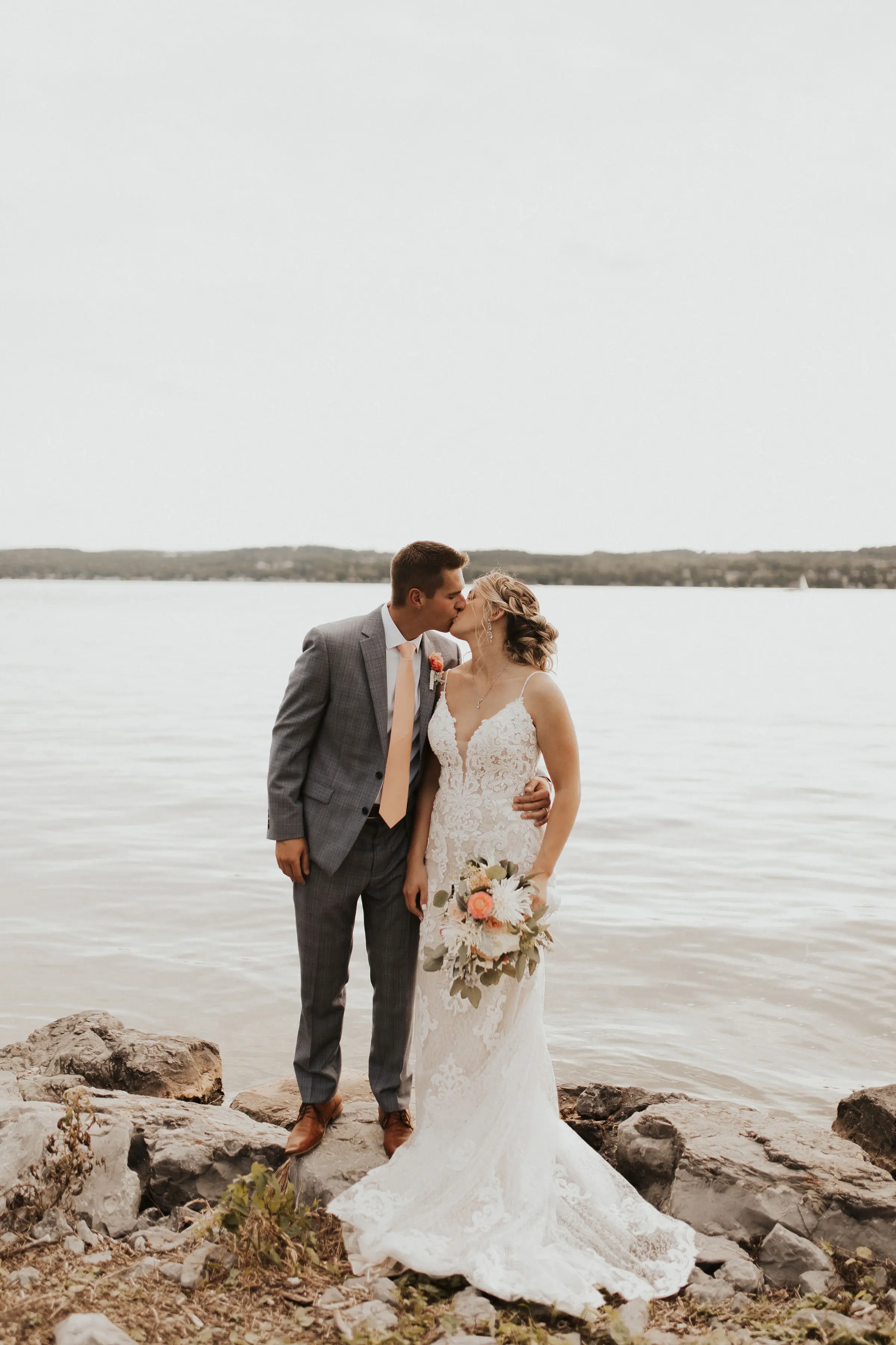 Bride Wearing Lace Sexy Wedding Dress Called Tuscany Lynette By Maggie Sottero With Groom By A Lake