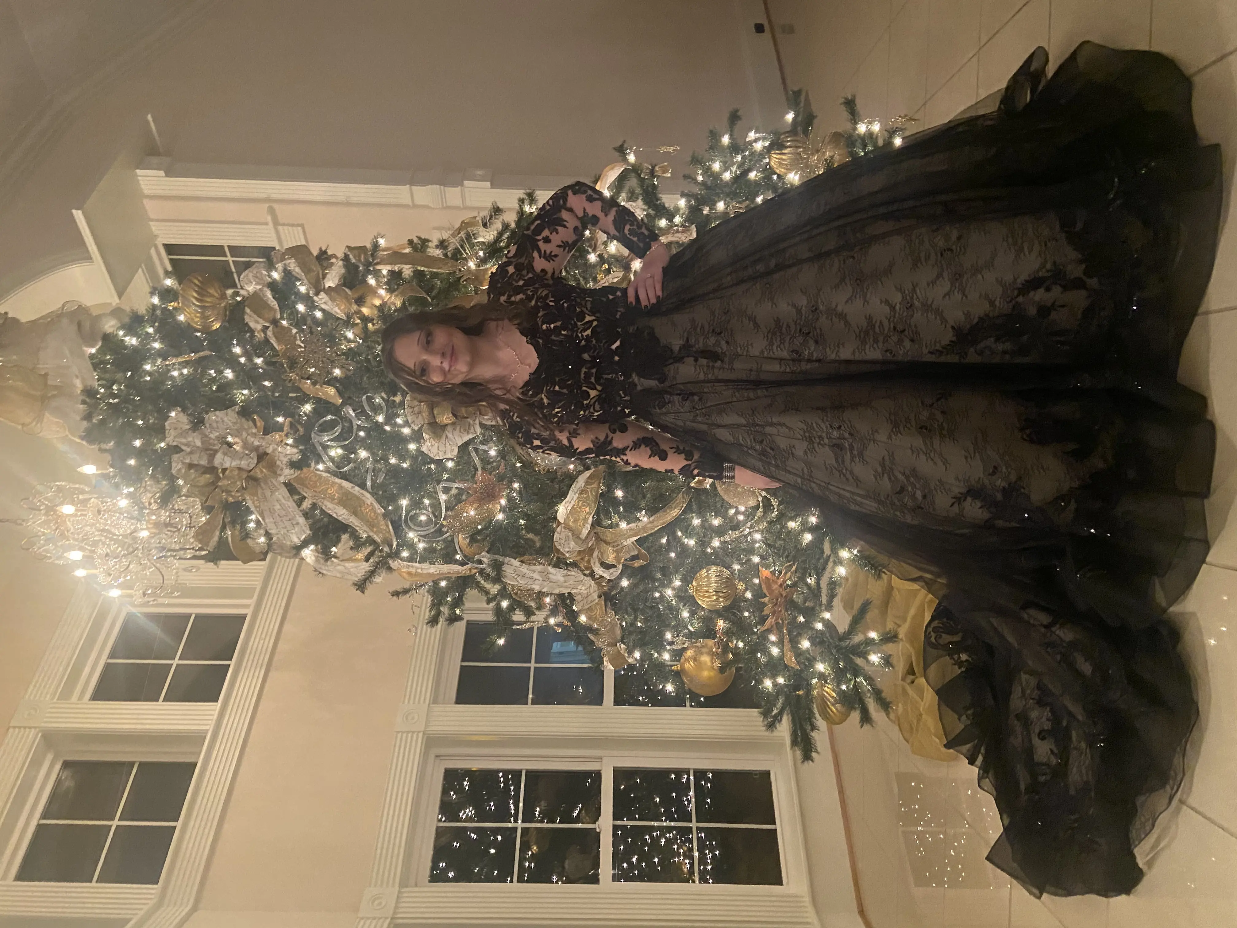 Bride Wearing Black Lace Ballgown Wedding Dress Called Zander By Sottero and Midgley In Front Of A Christmas Tree