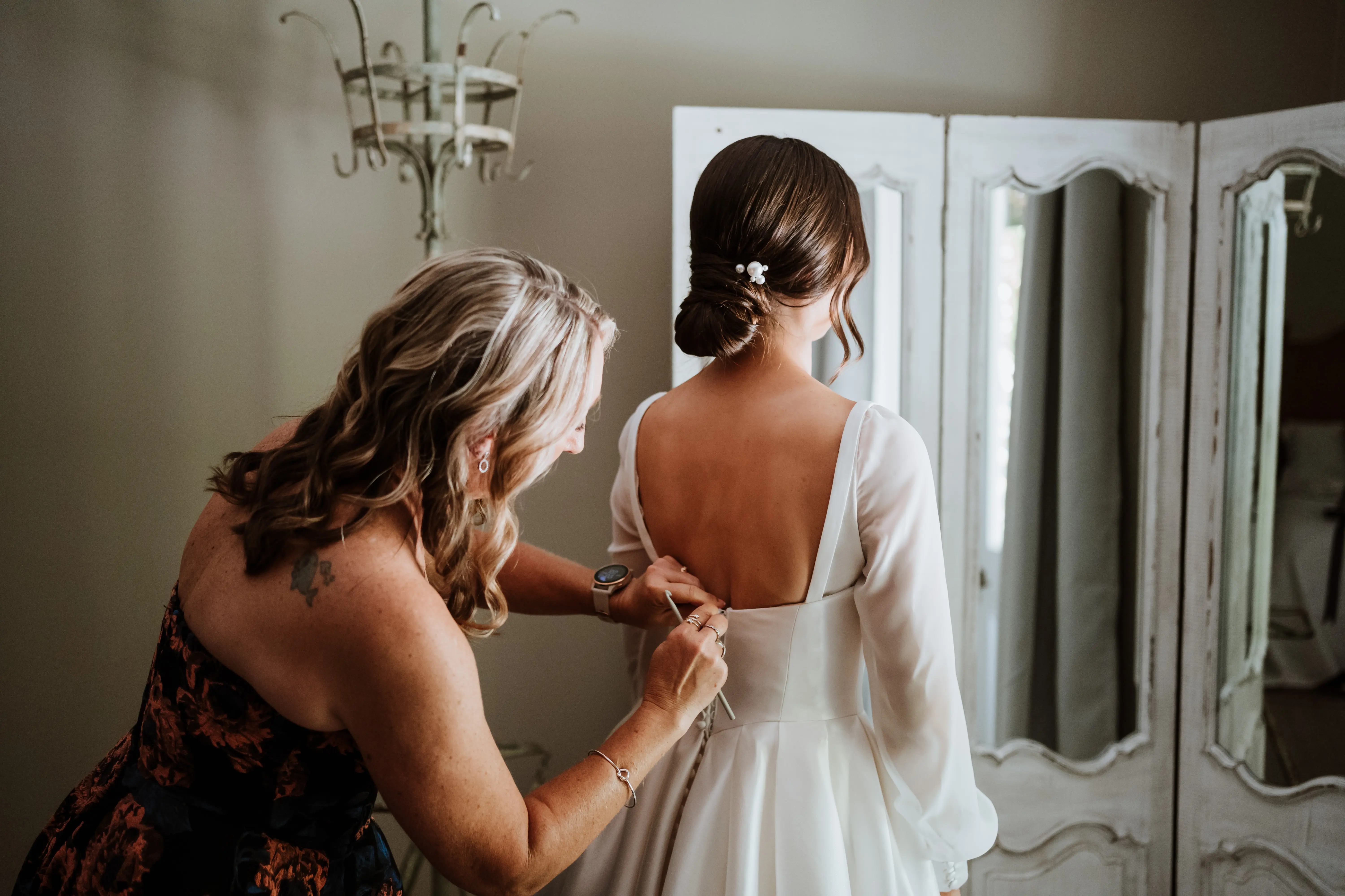 Mother of bride fastening wedding dress called Selena.