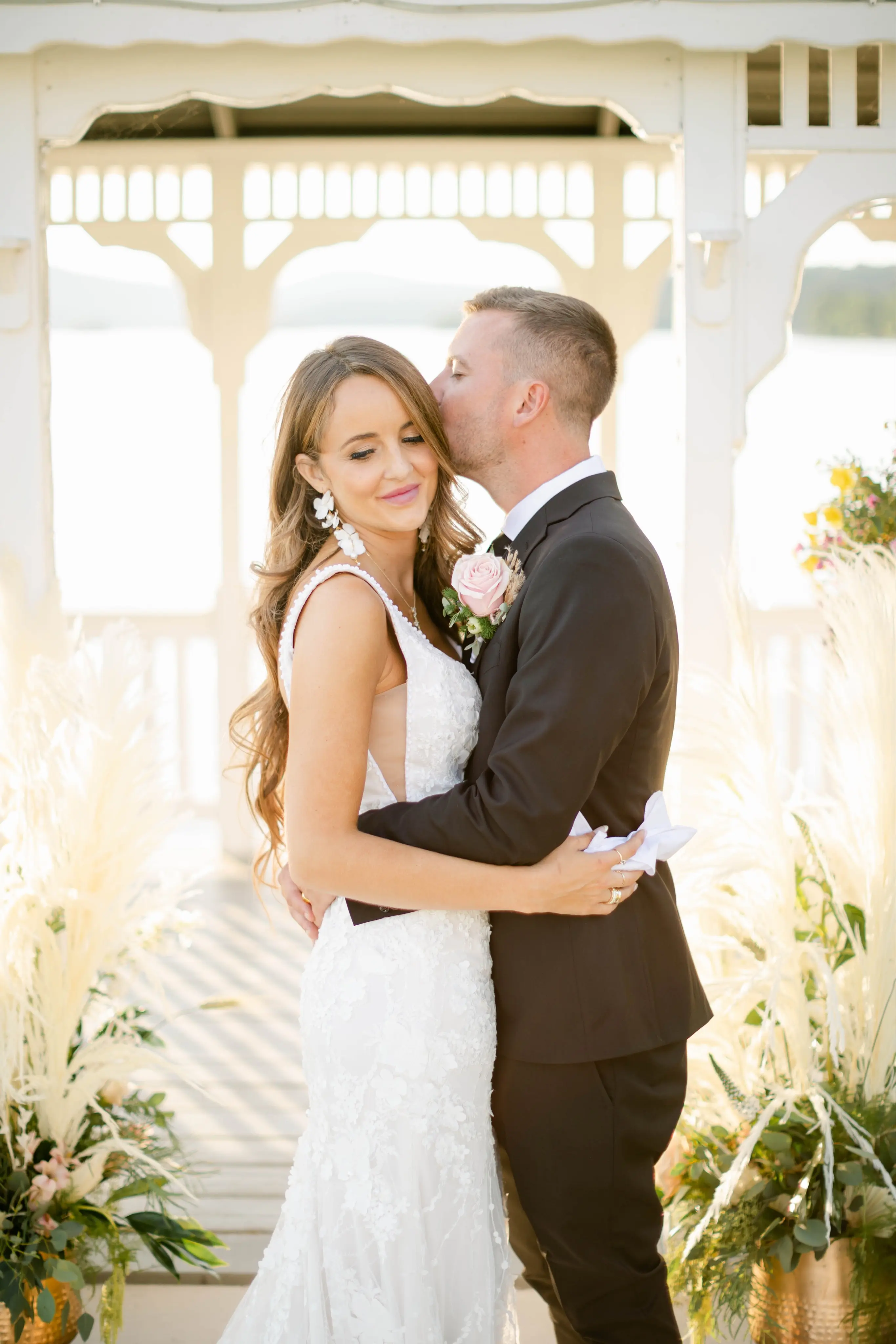 Groom Holding Bride in Mermaid Wedding Dress with 3-D Floral Motifs Called Cruz by Sottero & Midgley