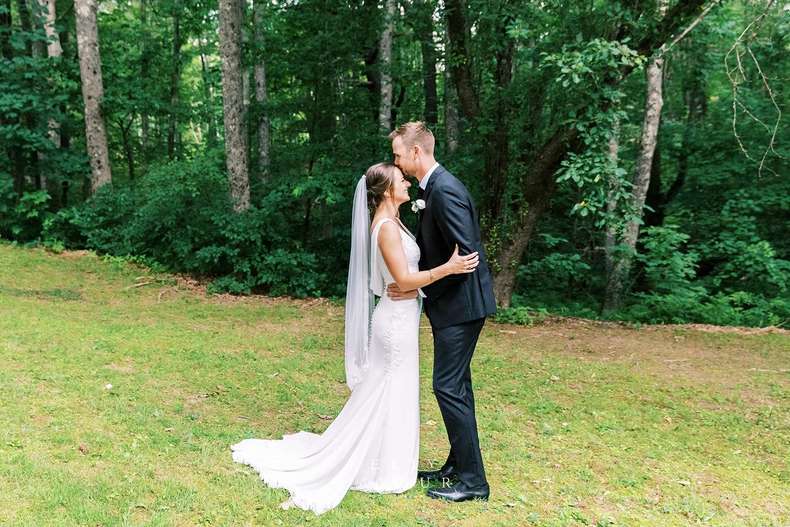 Groom with bride wearing simple crepe wedding dress Bertina by Maggie Sottero.