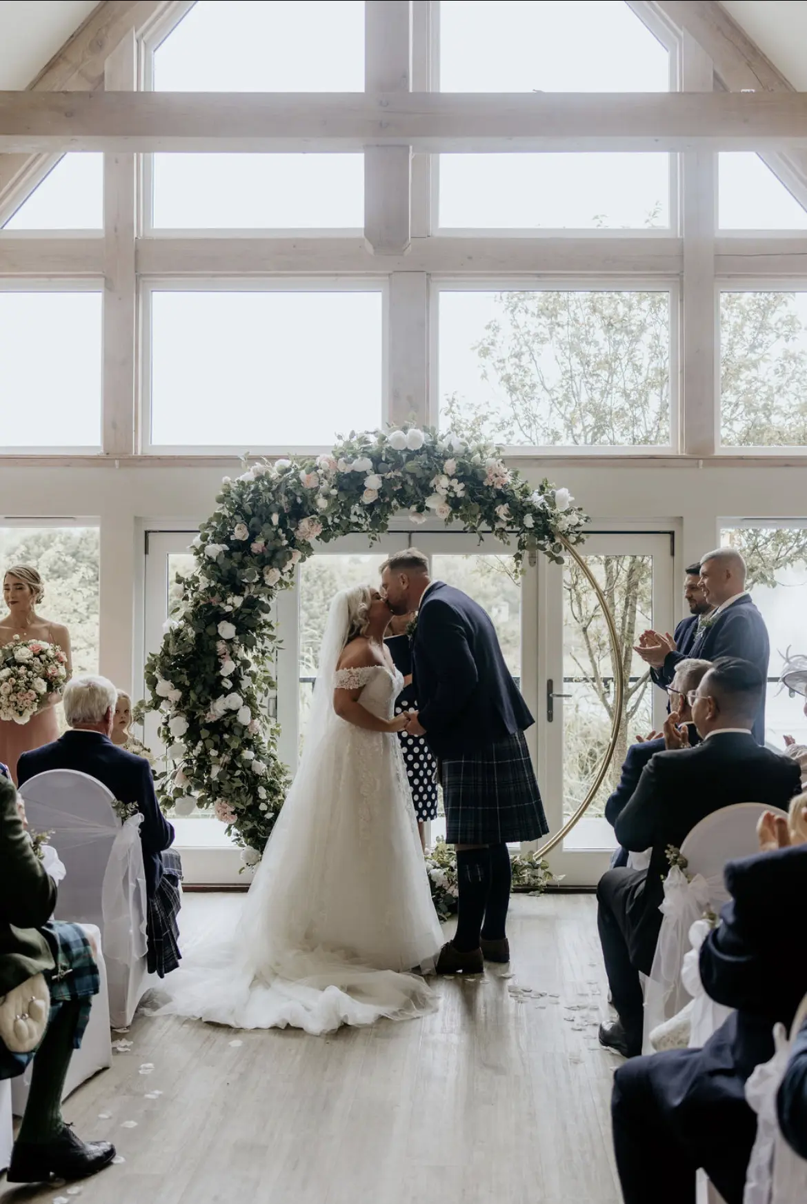 Bride wearing Rousseau wedding dress by Maggie Sottero kissing her husband