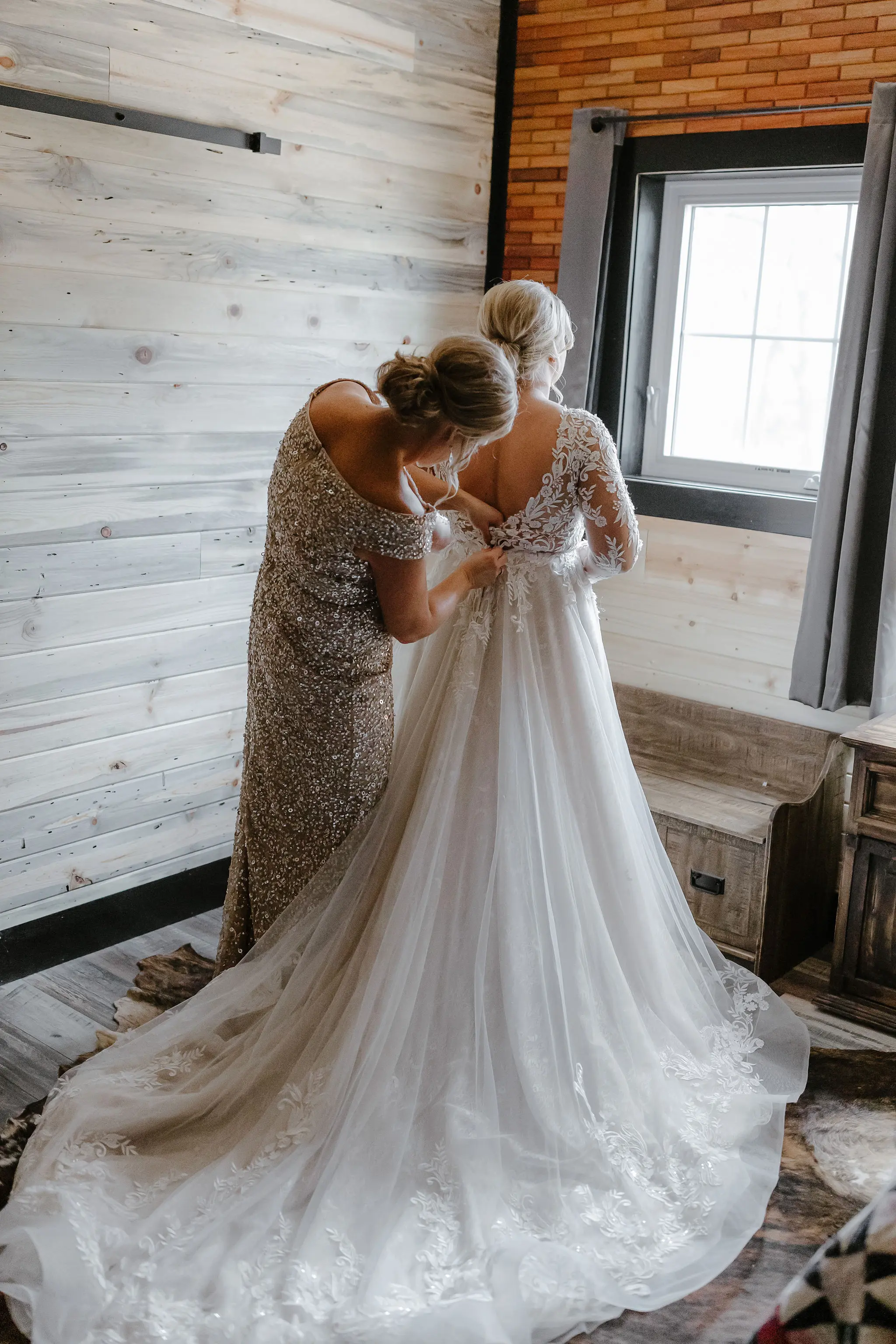 Bride Getting Ready Wearing Long Sleeve Ballgown With Low Back And Lace Details Called Zander By Sottero And Midgley