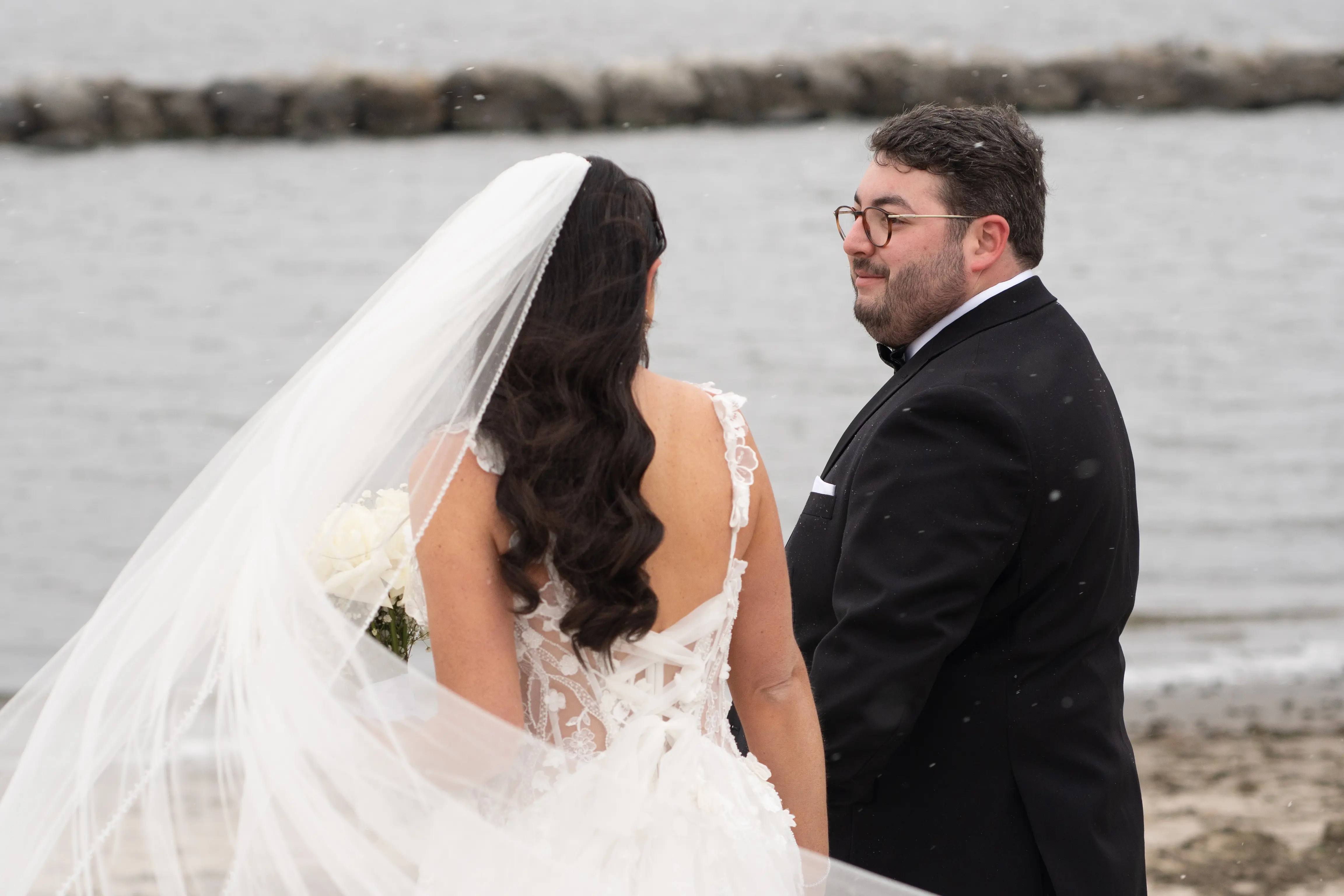 Bride Wearing Wicklow Wedding Dress By Sottero And Midgley And Groom Looking At Each Other On The Beach