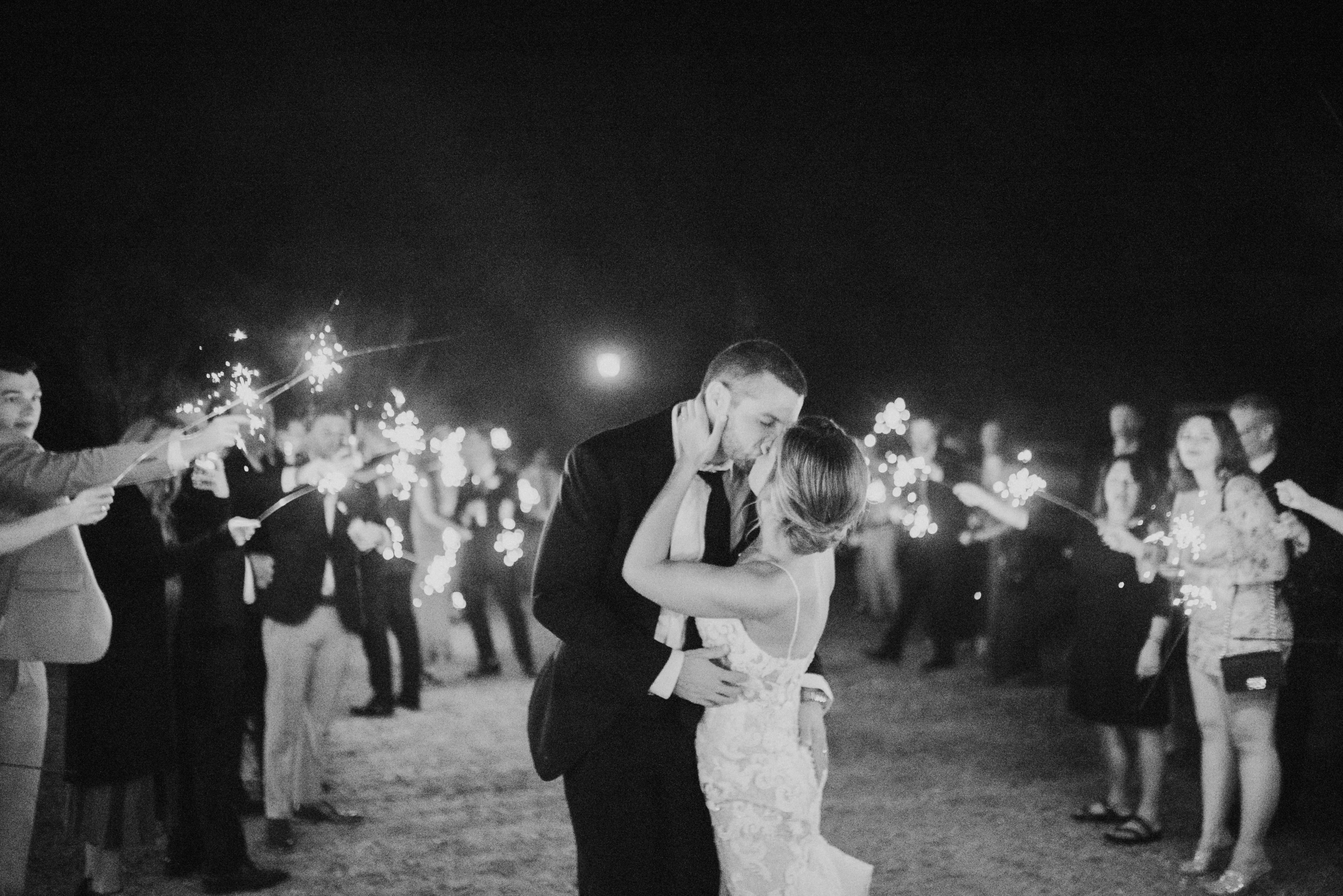 Groom Kissing Bride in Mermaid Wedding Dress with Shimmering Lace Motifs and Illusion Plunging Sweetheart Neckline Called Tuscany by Maggie Sottero