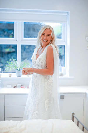 Bride wearing wedding dress called Tuscany Lane and smiling.