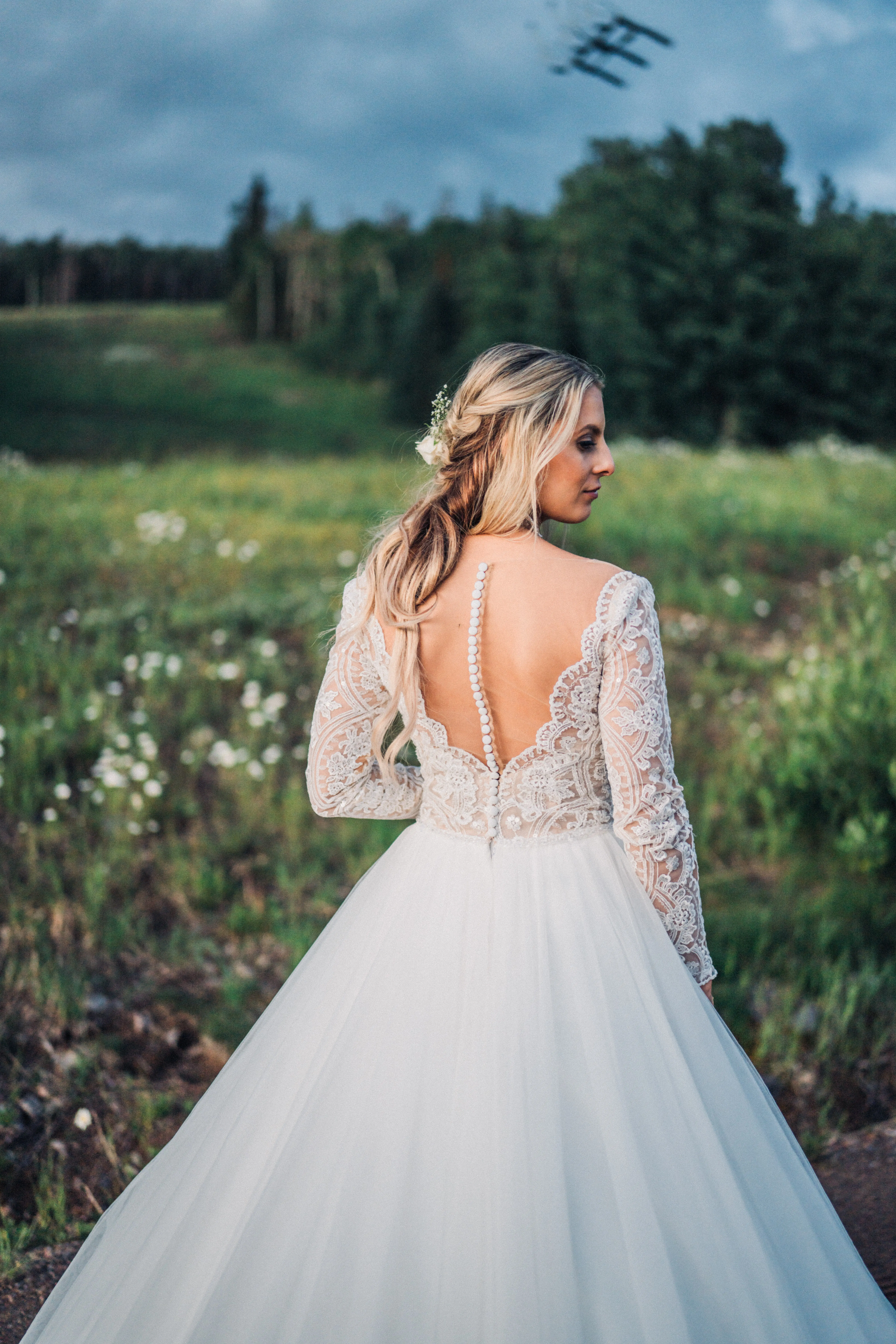 Bride wearing long sleeve lace ballgown wedding dress