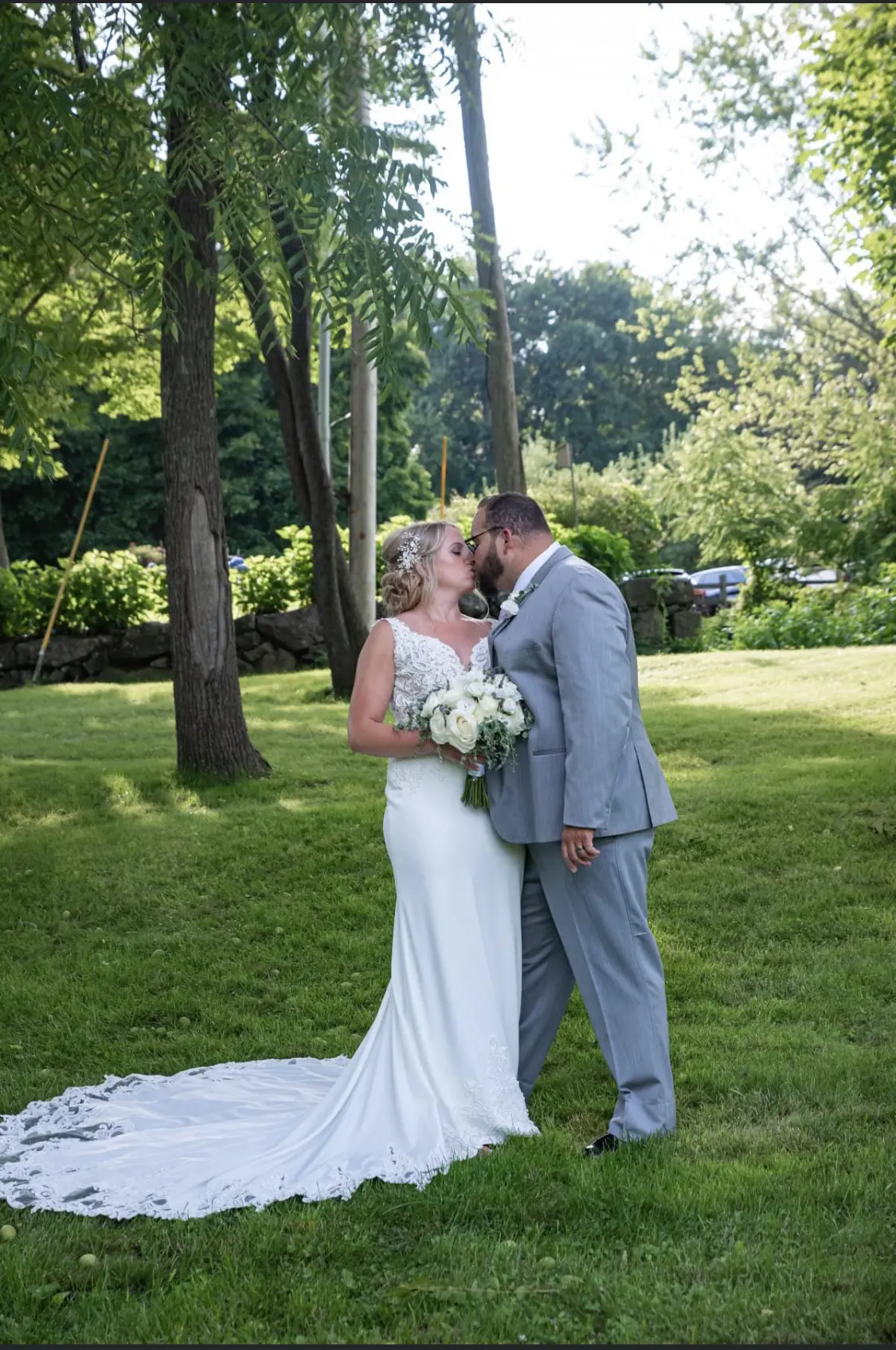 Bride with groom wearing lace crepe wedding dress
