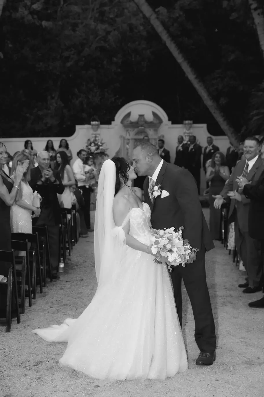 Bride And Groom Share Kiss. Bride Wearing Sparkly Fairytale Ball Gown Wedding Dress Called Shasta By Sottero And Midgley