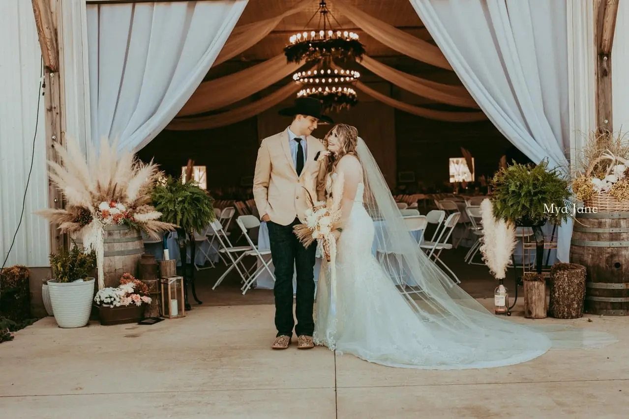 Bride wearing Frederique Royale wedding dress by Maggie Sottero with husband