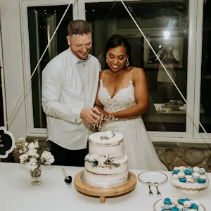 Bride wearing Flirty A-line Wedding Gown Called Savannah By Maggie Sottero Cutting The Cake with Groom