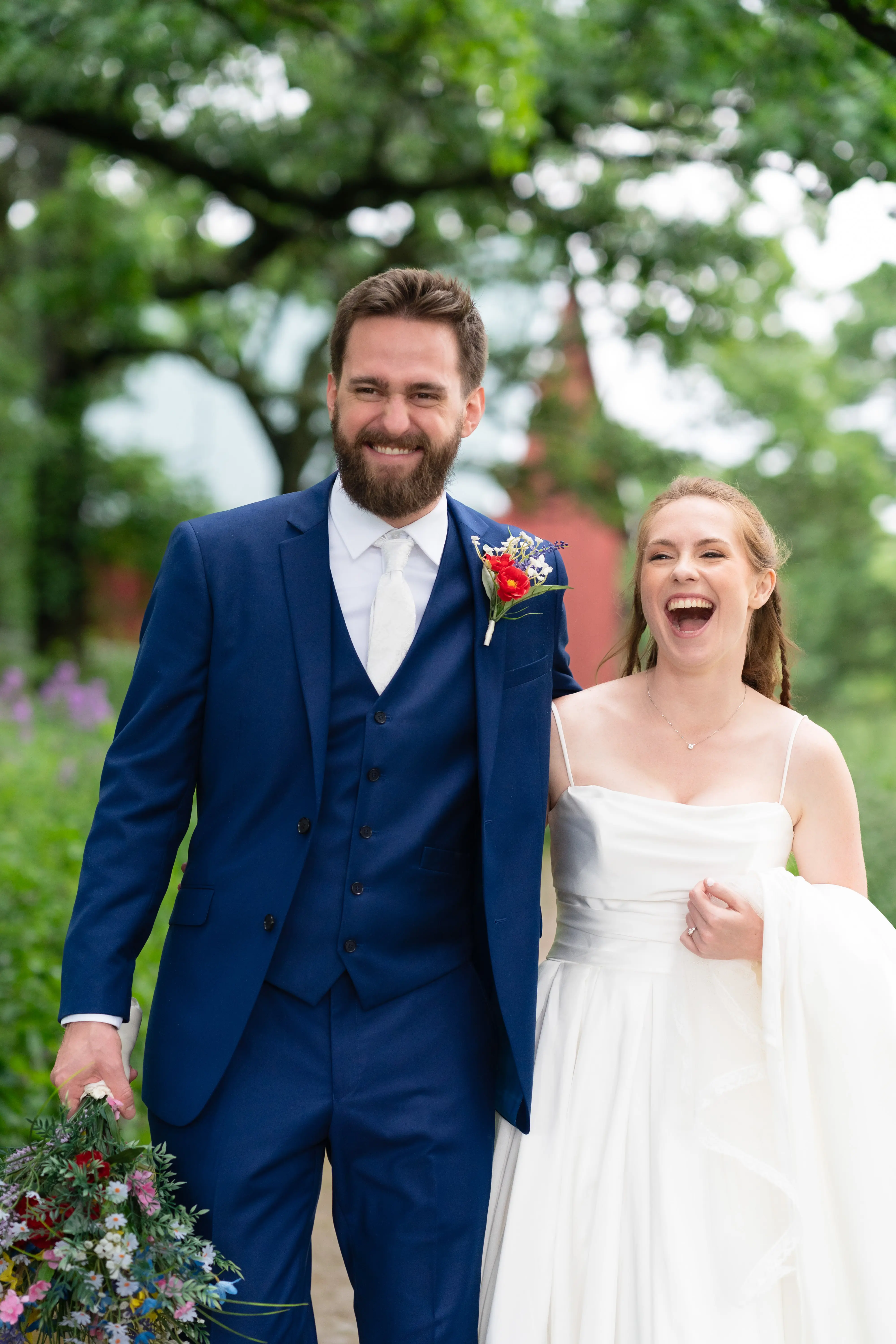 Bride wearing Scarlet by Maggie Sottero walking with her husband