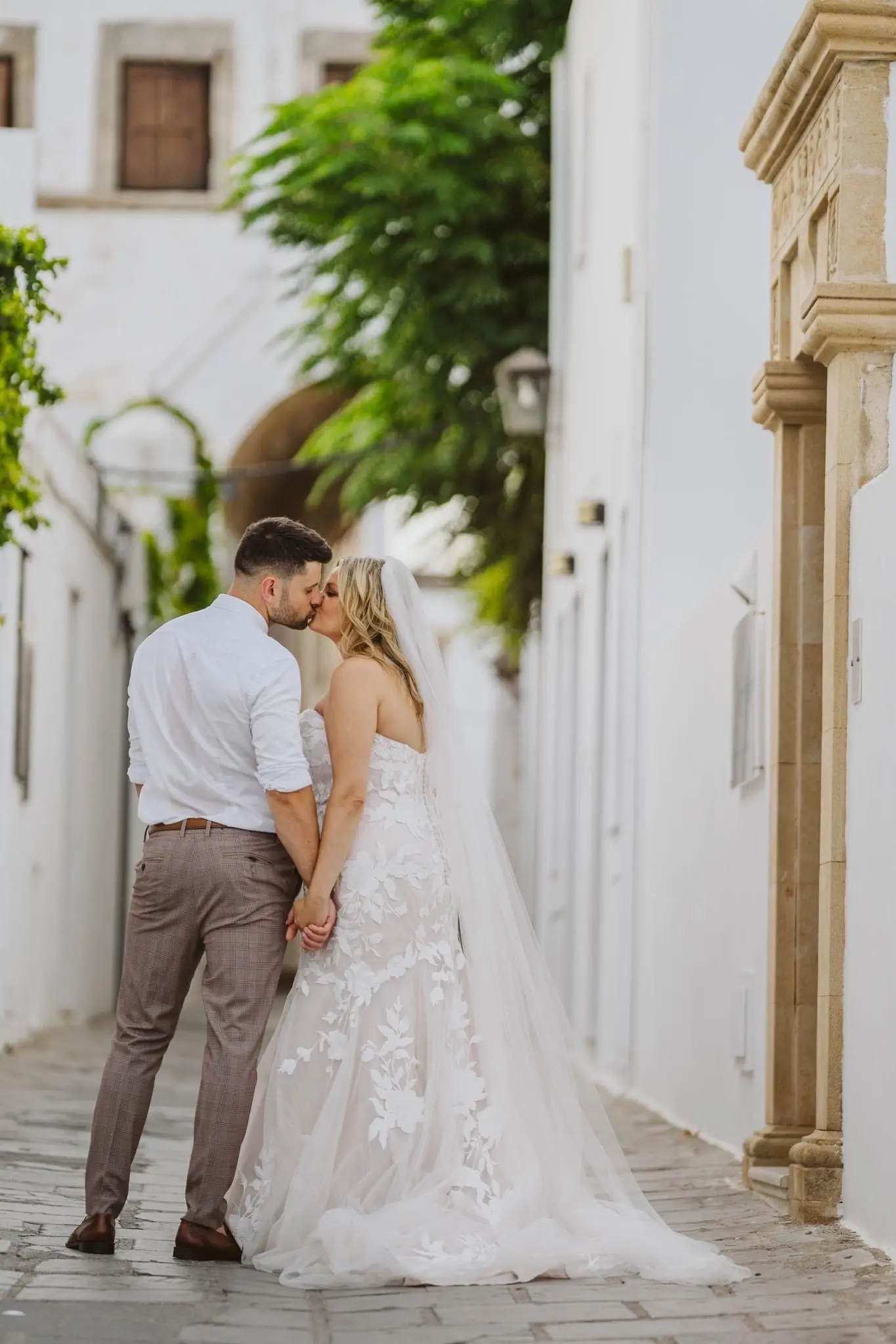 Bride wearing Hattie wedding dress by Rebecca Ingram kissing her husband