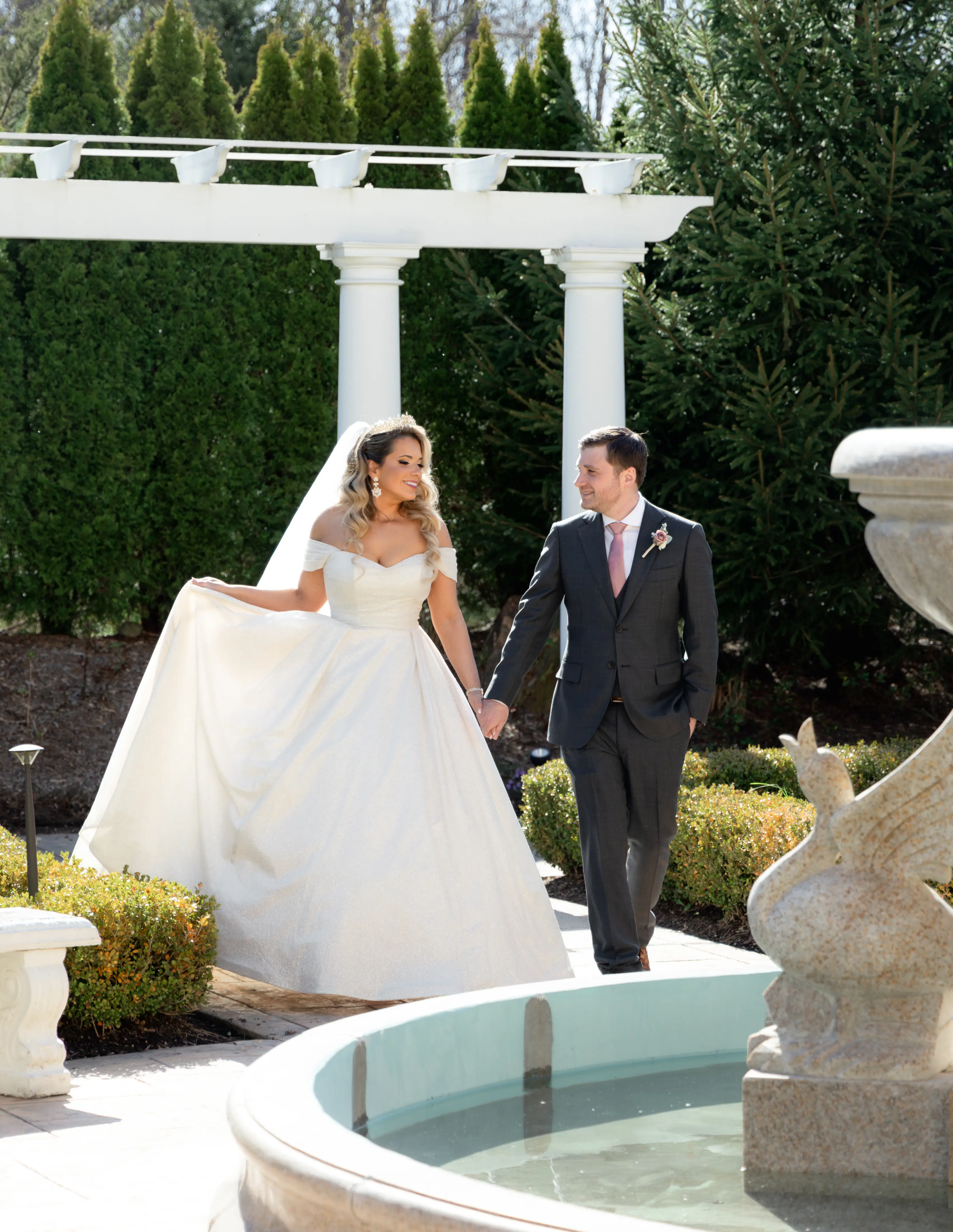 Bride wearing Anniston by Maggie Sottero holding hands with her husband