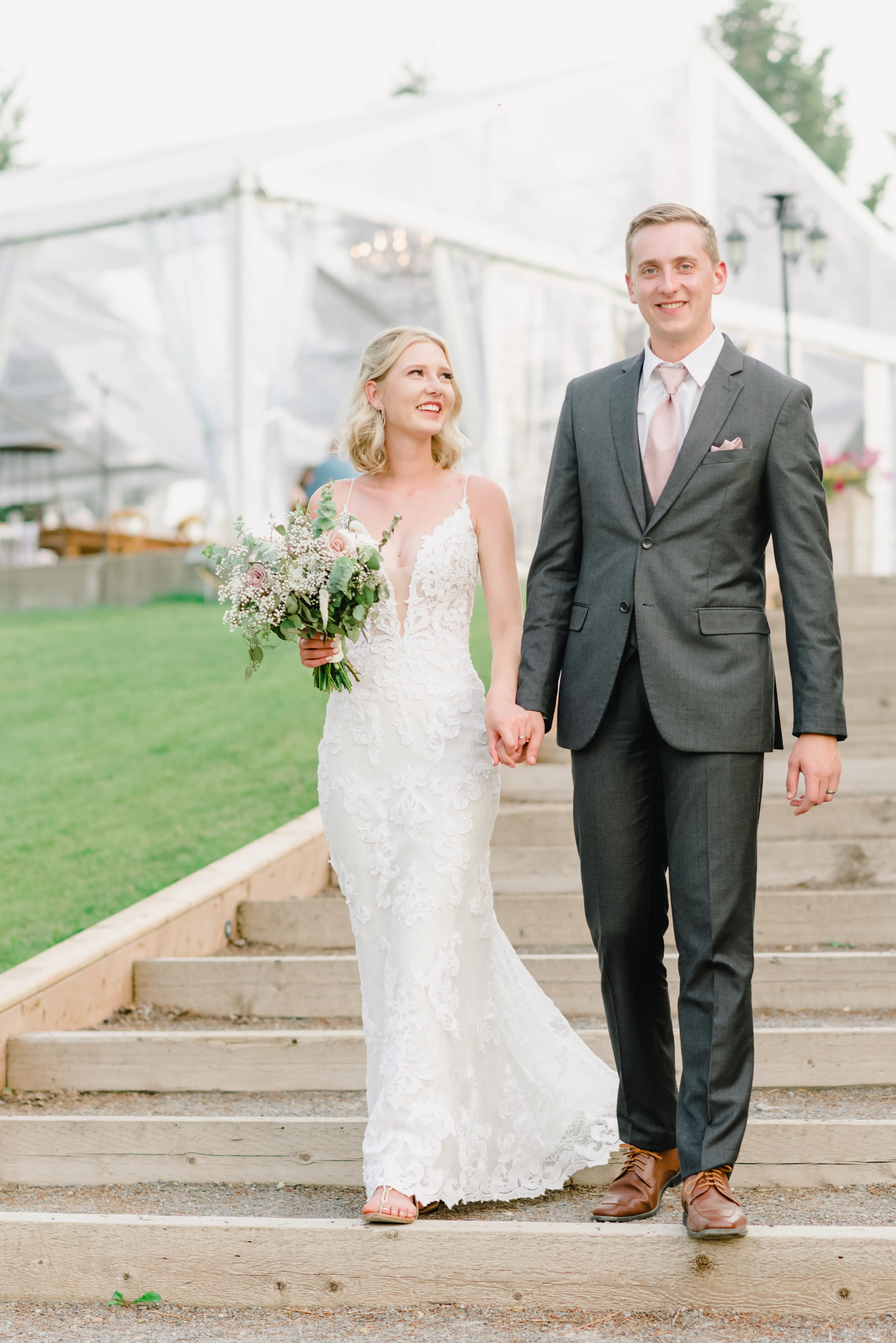 Bride with groom wearing lace sheath wedding dress