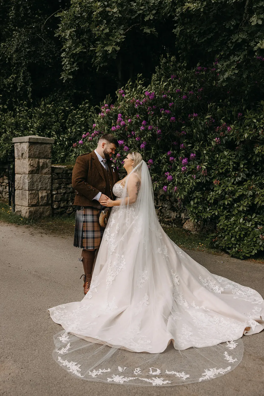 Bride wearing Norvinia by Sottero and Midgley standing outside with herhusband