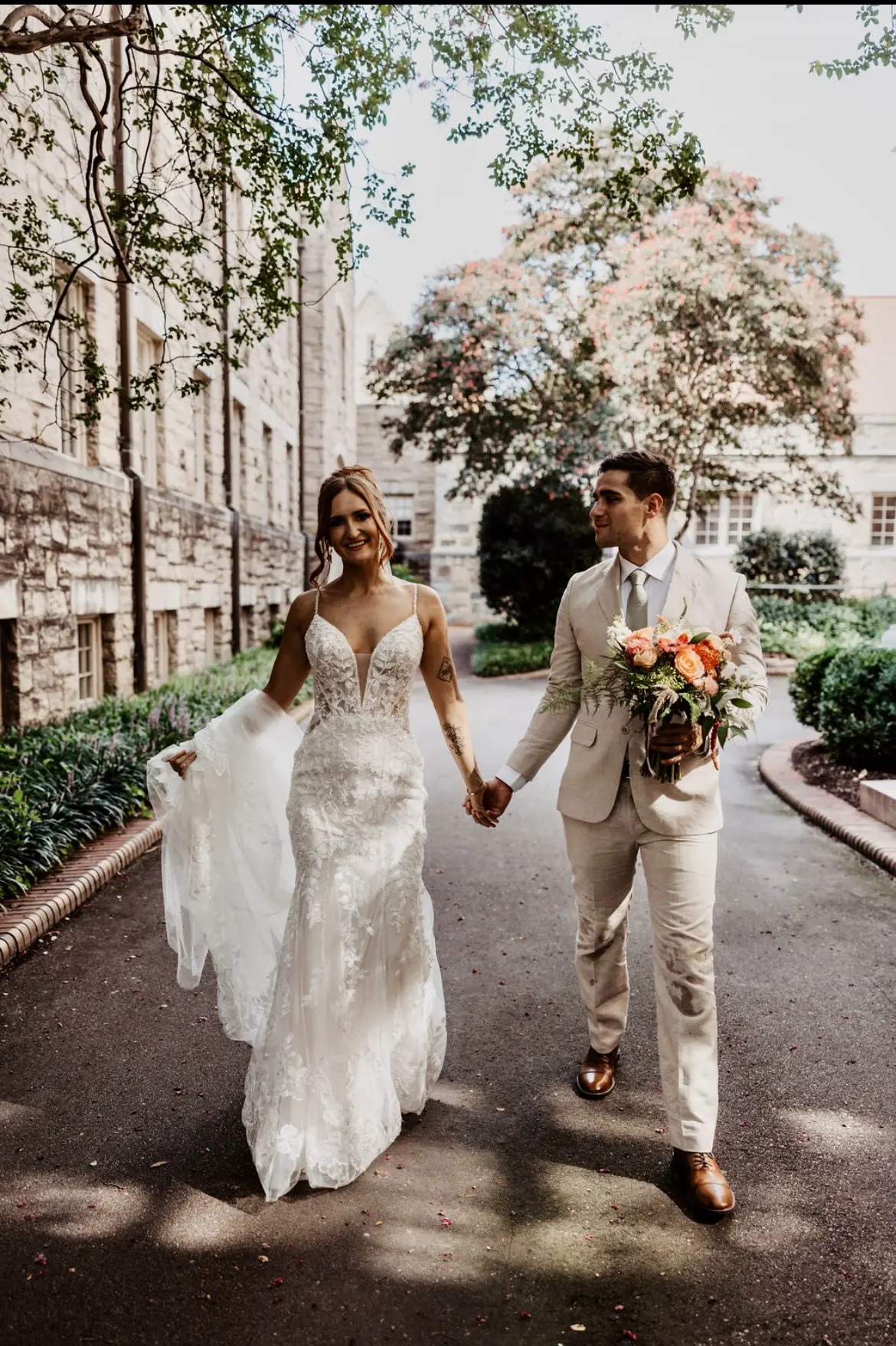 Bride wearing Sydney by Maggie Sottero holding hands with her husband