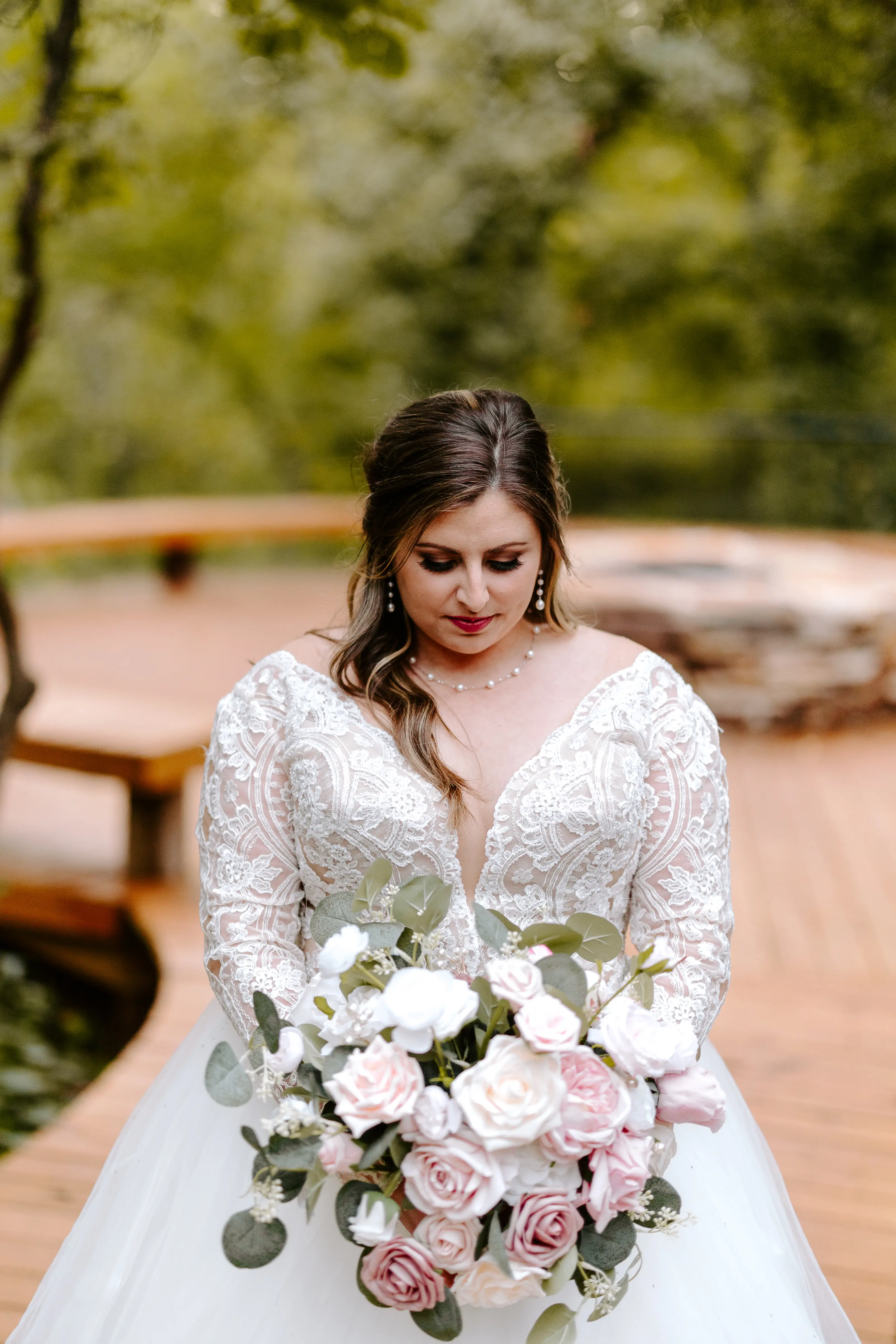 Bride Wearing Princess Wedding Dress Called Mallory Dawn By Maggie Sottero Holding A Light Pink Rose Bouquet