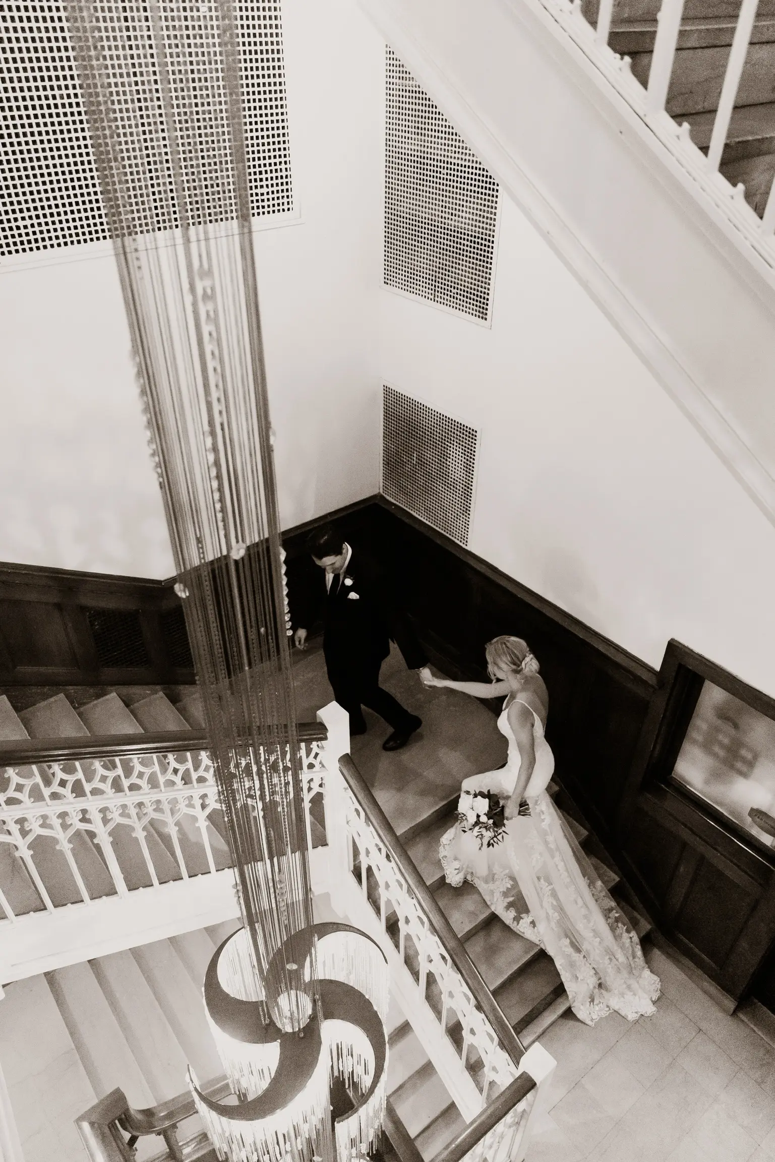 Bride Wearing Sparkle Lace Long Train Wedding Dress Called Fontaine By Maggie Sottero With Groom Walking Up Stairs