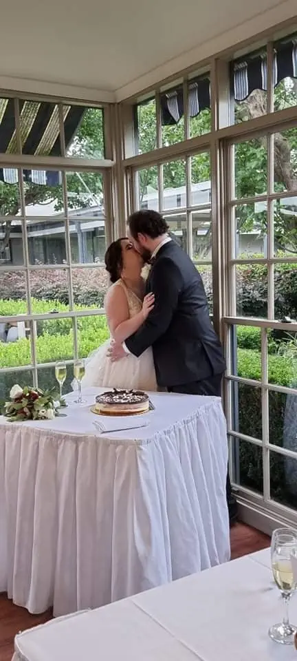 Groom Kissing Bride in A-Line Wedding Dress Raelynn by Rebecca Ingram