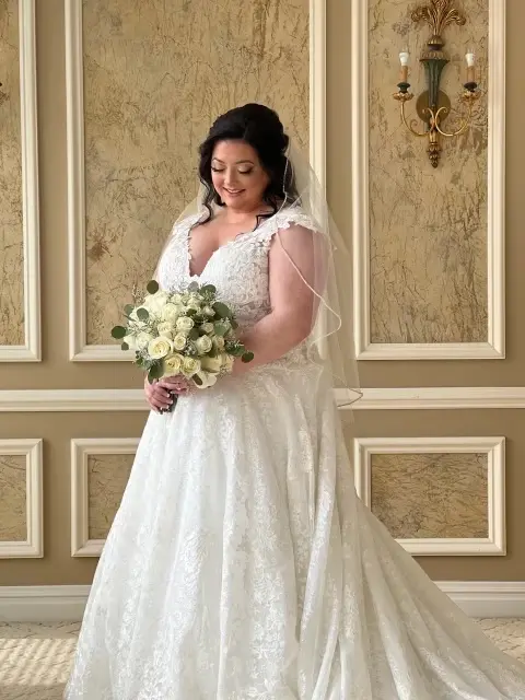 Bride Wearing Lace Ballgown Wedding Dress Called Kiernan By Sottero And Midgley Holding White Rose Bouquet