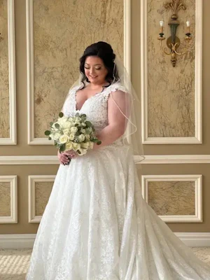 Bride Wearing Lace Ballgown Wedding Dress Called Kiernan By Sottero And Midgley Holding White Rose Bouquet