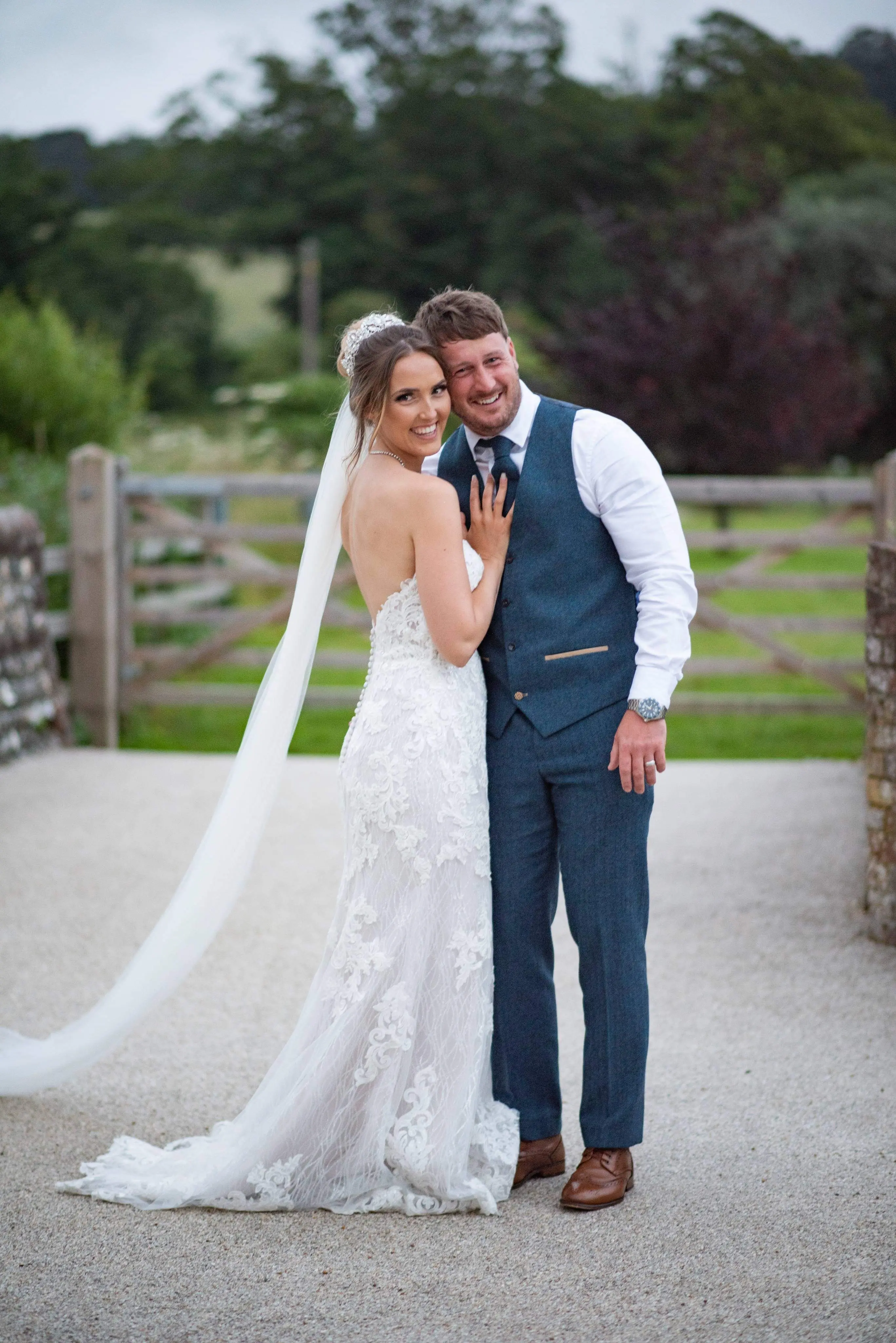 bride with groom in lacy mermaid wedding dress