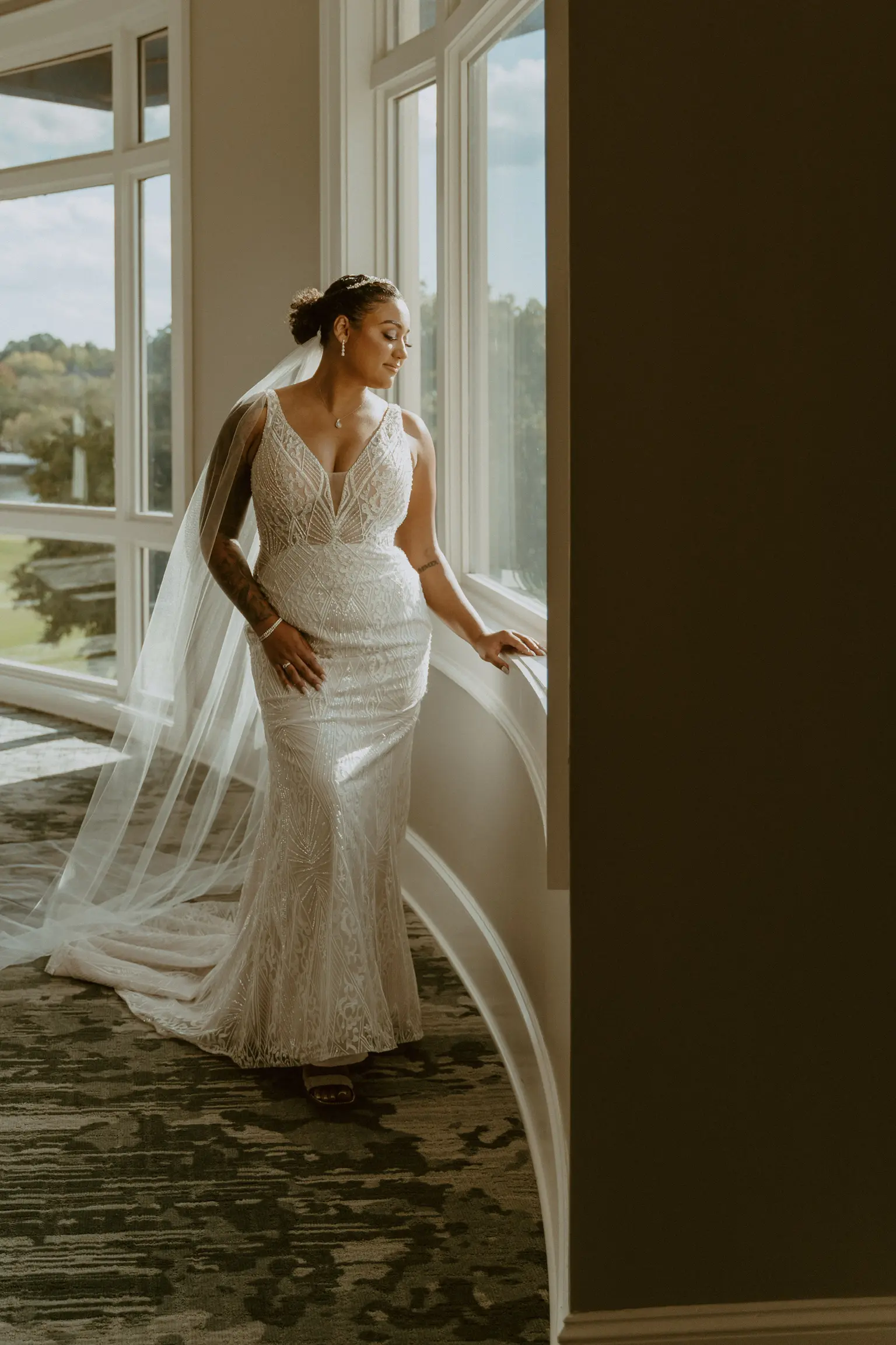 Bride wearing art deco-inspired beaded wedding dress with cathedral wedding veil.