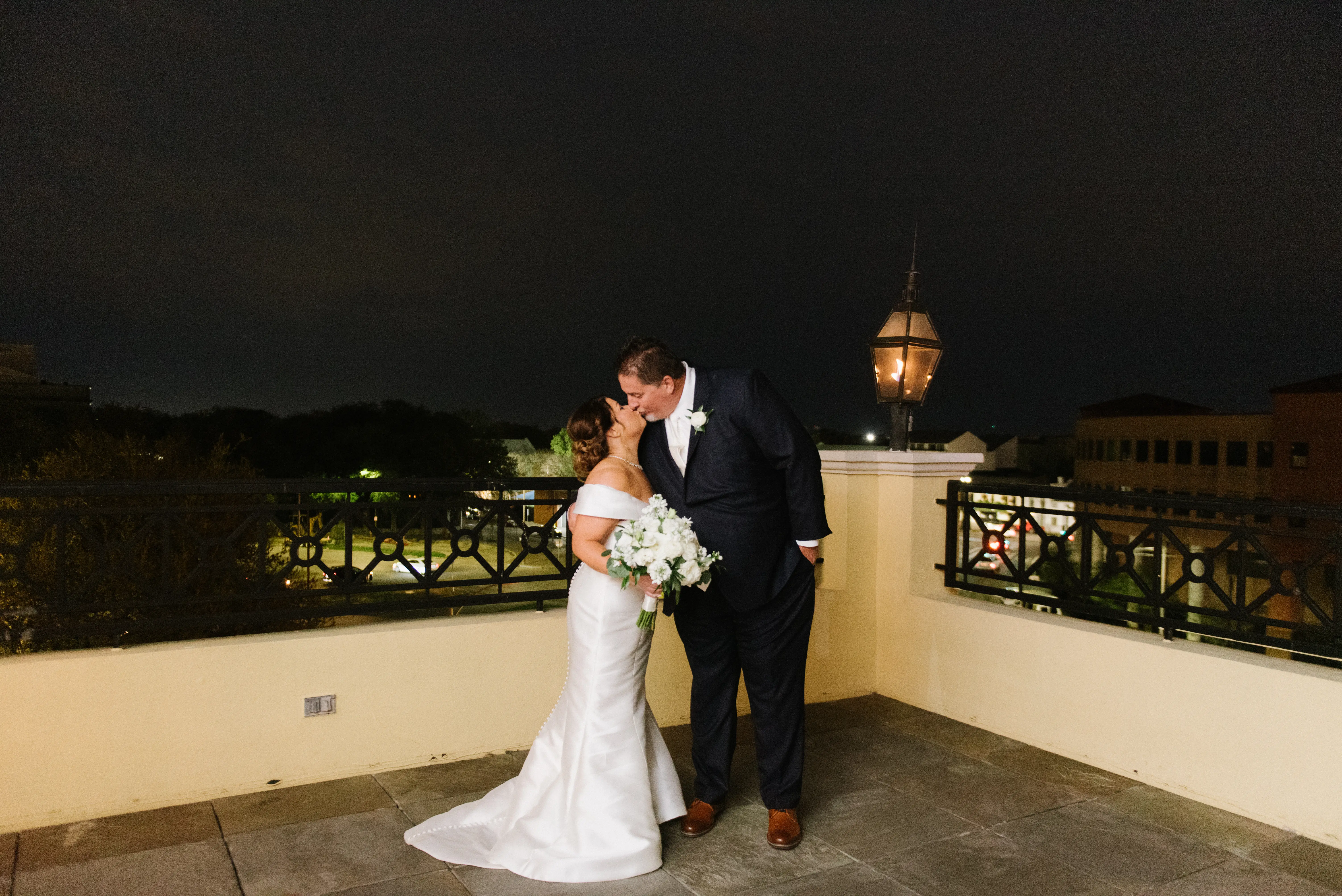 Bride with groom wearing elegant off the shoulder wedding dress