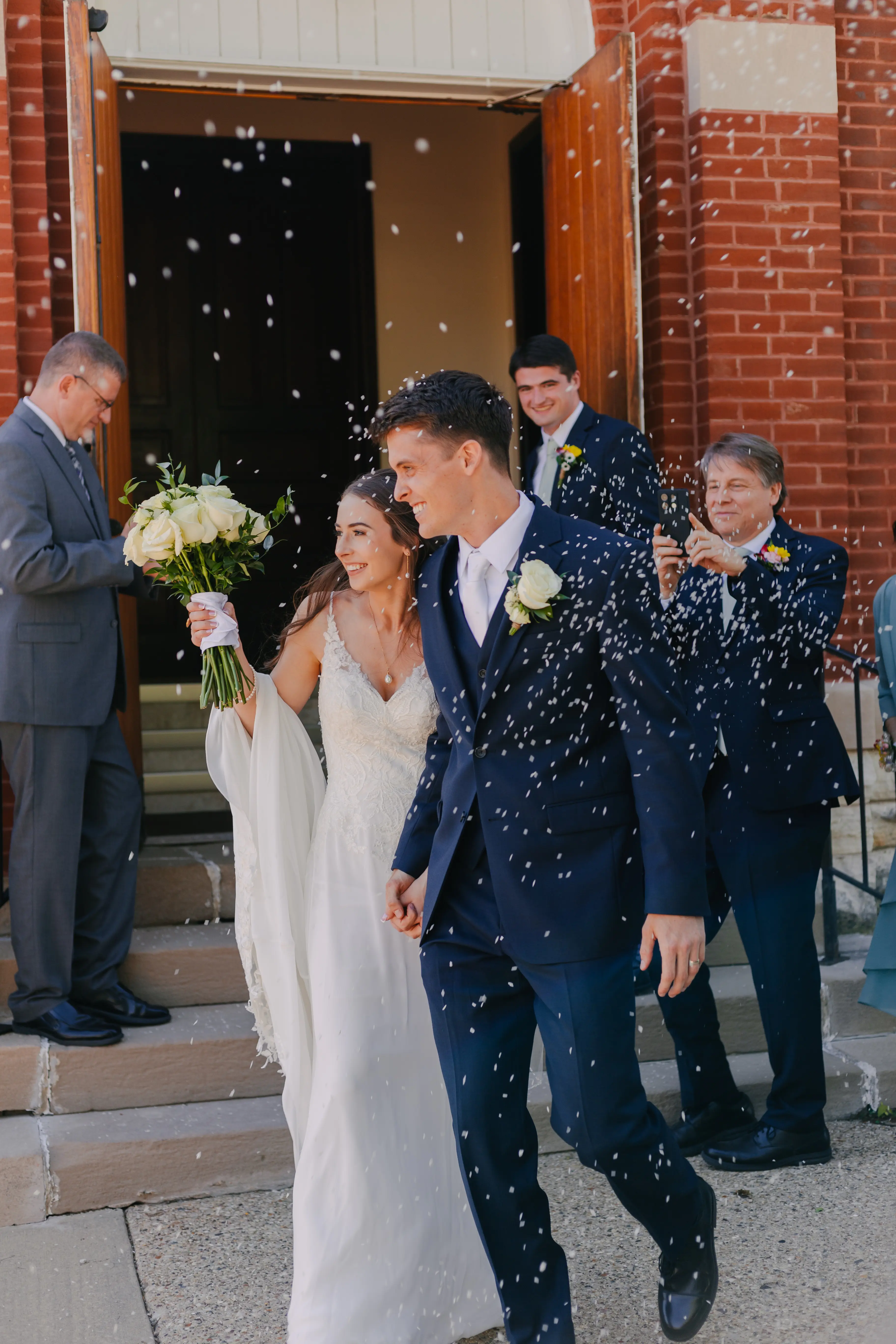 Bride wearing Charlotte by Rebecca Ingram doing their flower petal exit