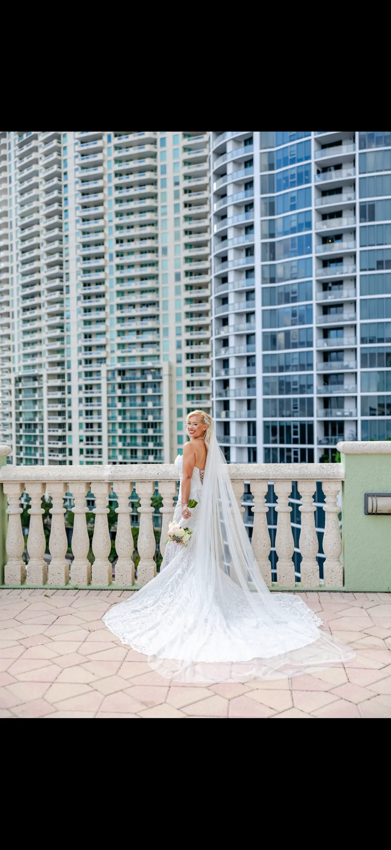 Bride Wearing Lace Mermaid Wedding Dress Called Bronson By Sottero And Midgley On A City Balcony